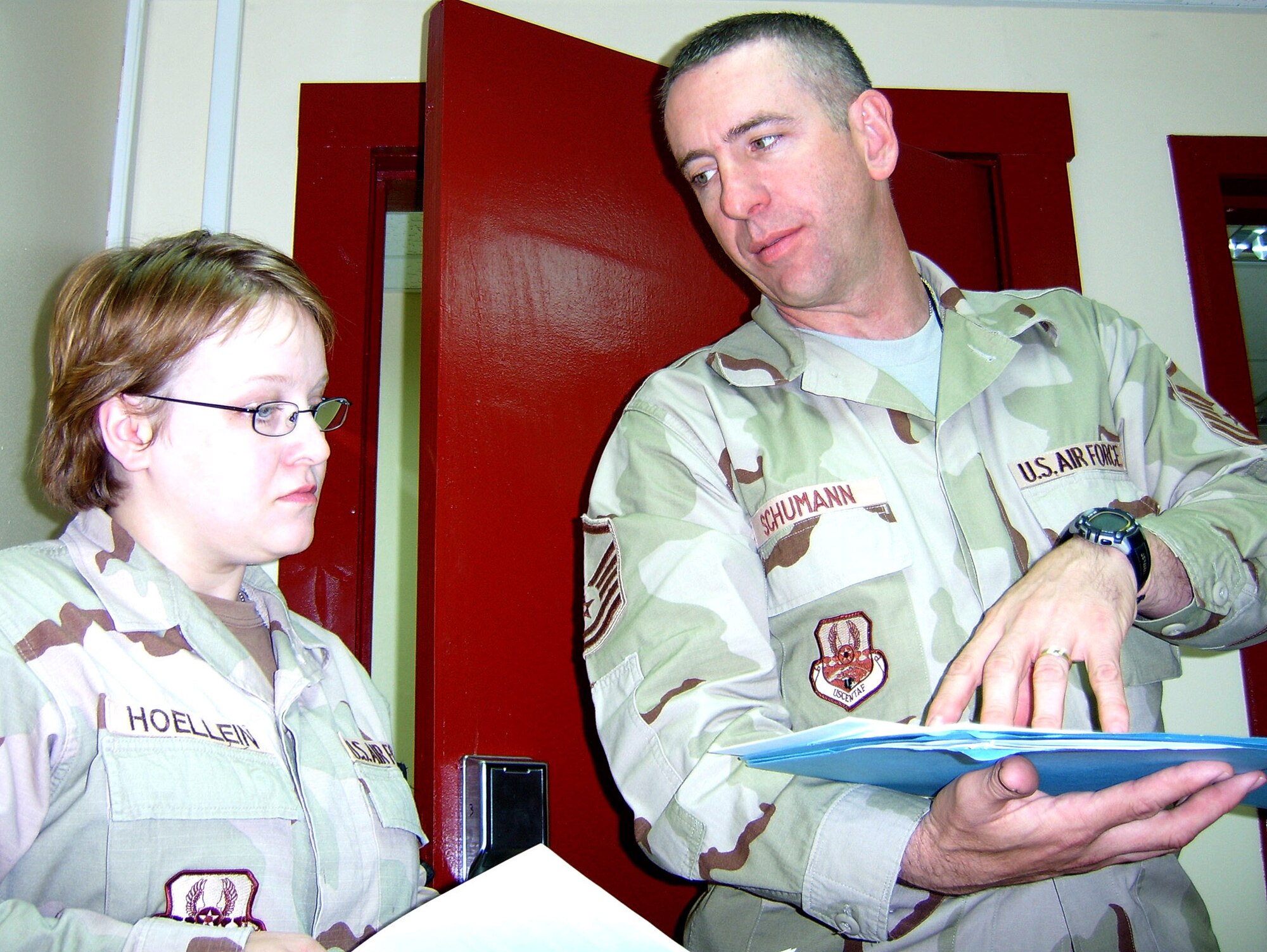 Master Sgt. John Schumann discusses training with Master Sgt. Alexandra Hoellein, Military Equal Opportunity duty liaison during a July 25 site visit to Kirkuk Air Base, Iraq. Sergeant Schumann is the 332nd Air Base Wing Military Equal Opportunity chief and the only MEO Airman assigned to Iraq, so he is assisted by liaisons at geographically-separated units. (U.S. Air Force photo/Staff Sgt. LuCelia Ball)