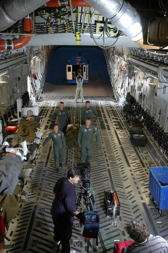 Members of the 315th Aeromedical Evacuation Squadron, Charleston AFB, S.C., perform a mock-patient onload during the filming of the next Air Force Reserve commercial.  (Photo by Staff Sgt. Jeff Kelly, USAFR)