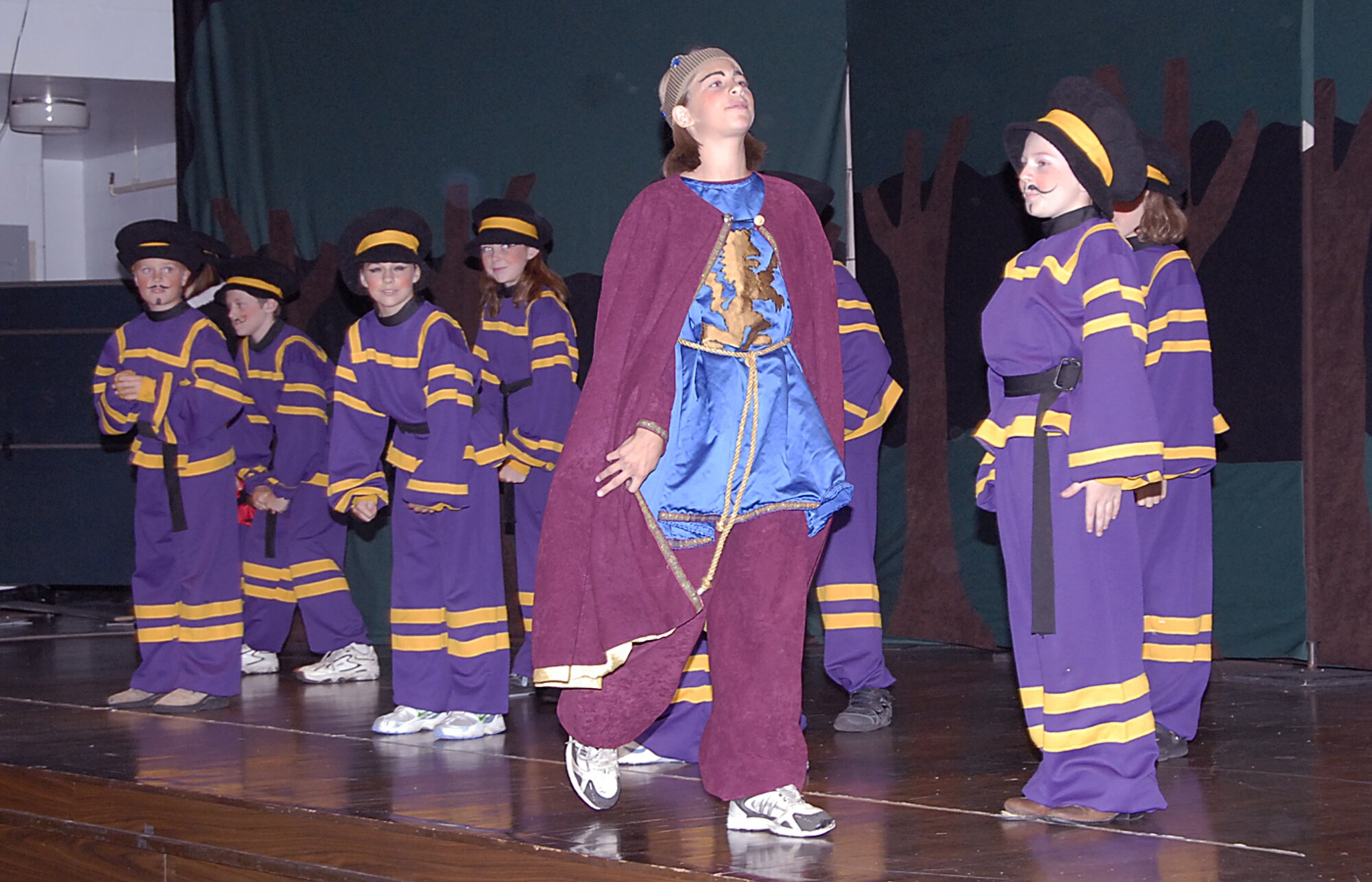 Prince John, played by Lauren Moon, strides past a group of royal guards at the Missoula Children's Theater production of Robin Hood July 27 at the Community Activity Center. (U.S. Air Force photo/Harry Tonemah)