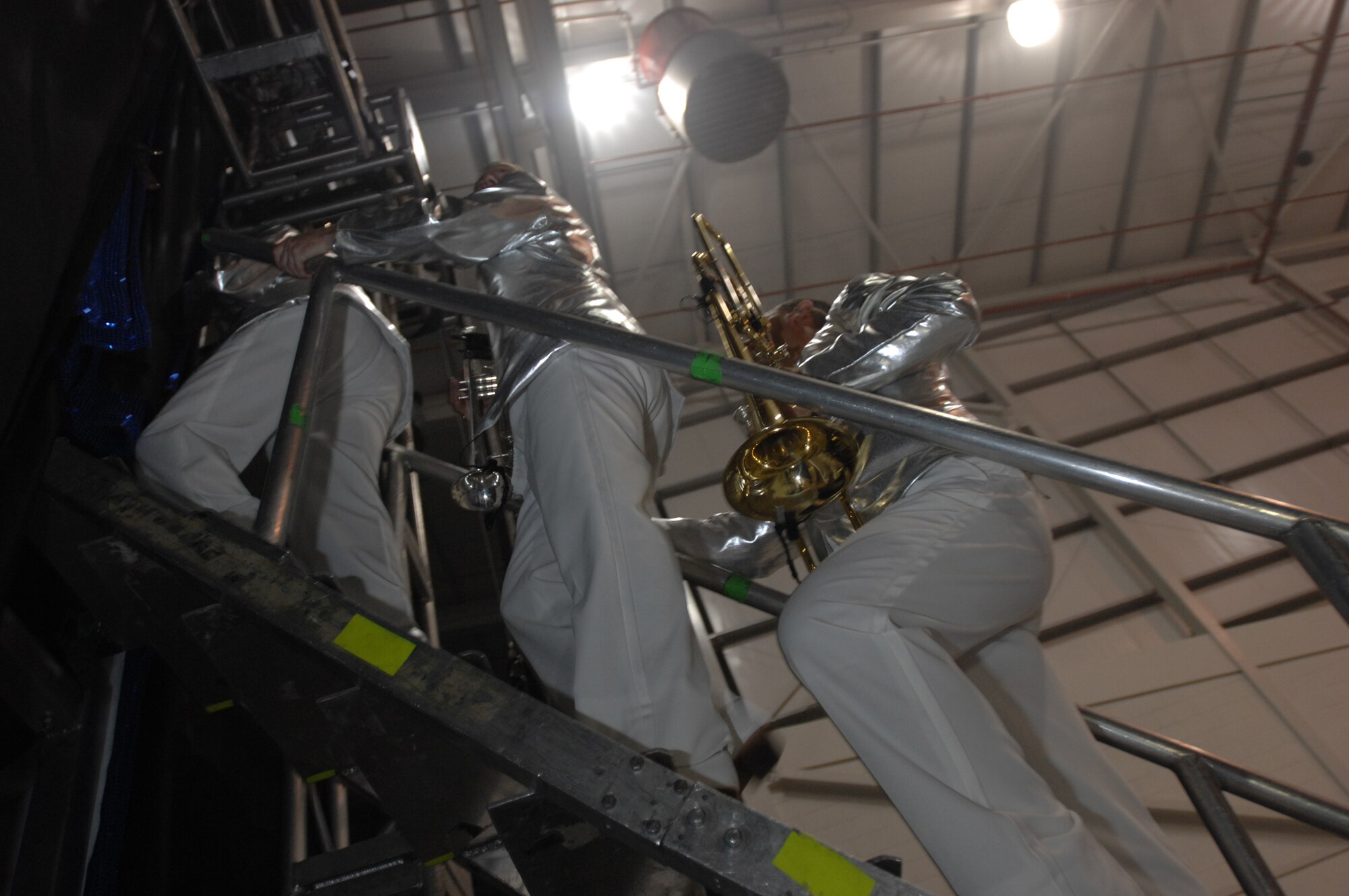 The brass section of the 2007 Tops In Blue band stand ready for their entrance to the stage for the second to last set of music during the RAF Mildenhall performance, July 25, 2007. Out of all the performers, the band members had the least but quickest wardrobe changes. (U.S. Air Force photo by Tracy L. DeMarco)