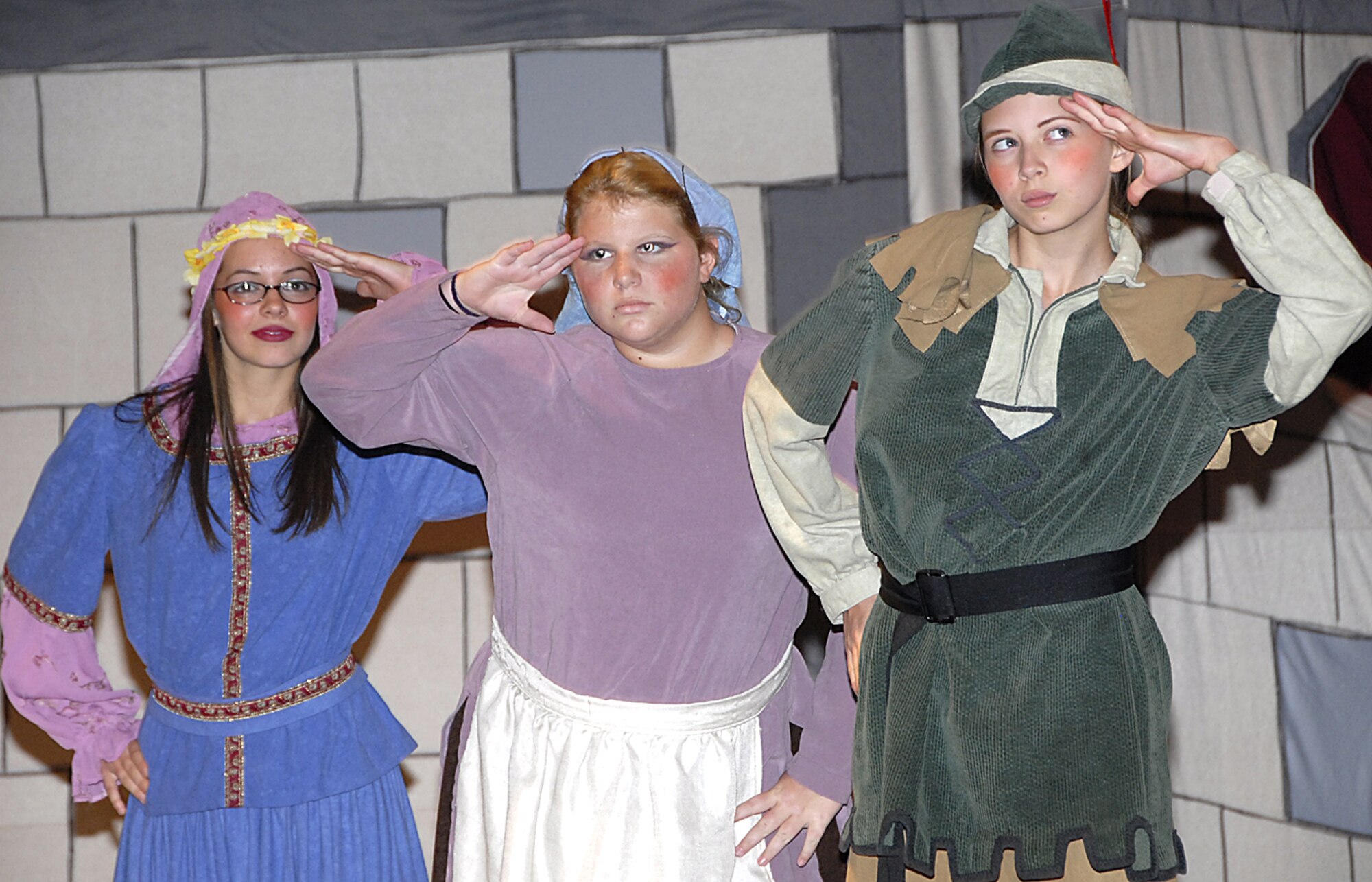 (From left to right) Maid Marion, played by Laura Gilman, Marion's Maid, played by Dakota Simpson, and Robin Hood, played by Emily Gilman, perform on stage at the Missoula Children's Theater production of Robin Hood July 27 at the Community Activity Center. (U.S. Air Force photo/Harry Tonemah)