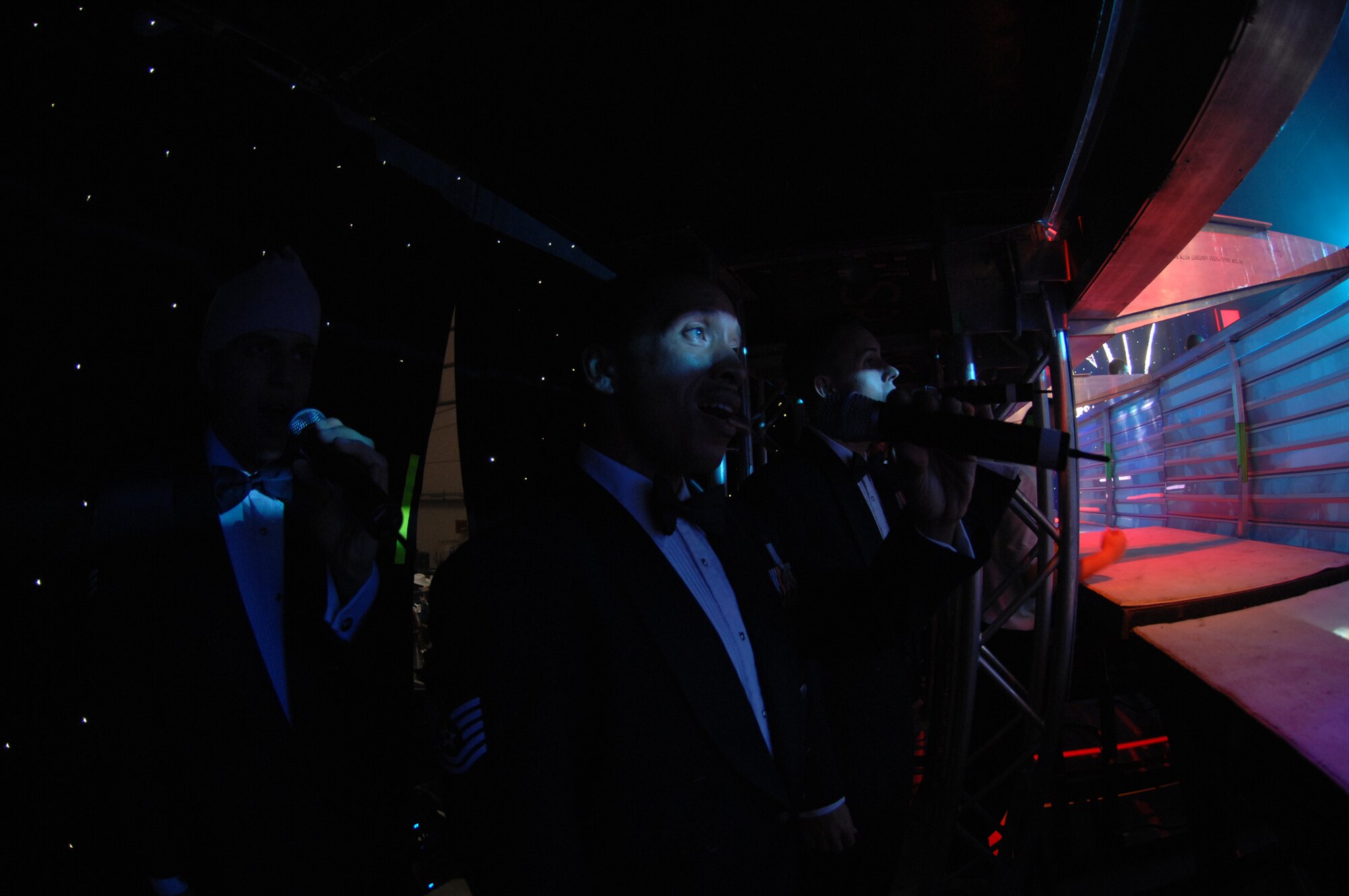 "Let's do this," Tech. Sgt. Keith Martin, Sr., said as the male vocalists began singing the final set of music from backstage during the RAF Mildenhall performance, July 25, 2007. Once the lift in the middle of the stage was lowered, the men stepped on and were raised into position. (U.S. Air Force photo by Tracy L. DeMarco)