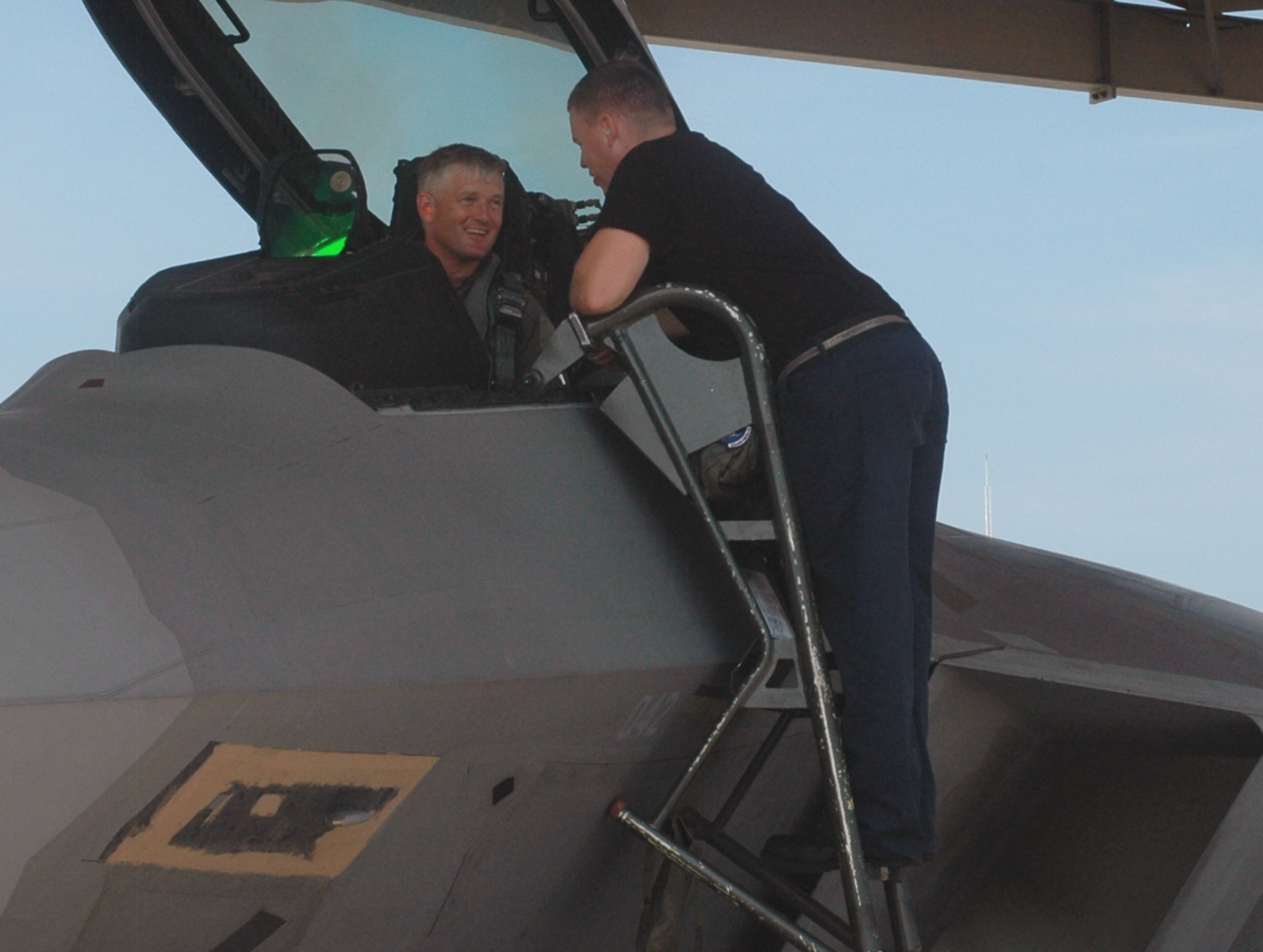 Col. William Mott, 325th Operations Group commander, discusses F-22 take-off procedures with Senior Airman Dennis Futrell, 43rd Aircraft Maintenance Unit crew chief, prior to launching the jet. (U.S. Air Force photo/Staff Sgt. Vesta Anderson)