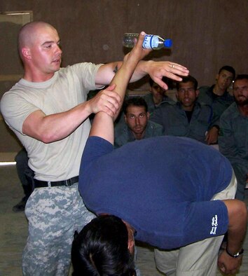 Staff Sgt. Daniel Smith teaches a class of Afghanistan national police students at Forward Operating Base Mehtar Lam, Afghanistan. Sergeant Smith is the Provincial Reconstruction Team Police Tactics and Refresher Training NCO in charge, and has trained more than 200 Afghanistan national police and Afghanistan national auxiliary police members since arriving in Afghanistan April 1. (U.S. Air Force photo)
