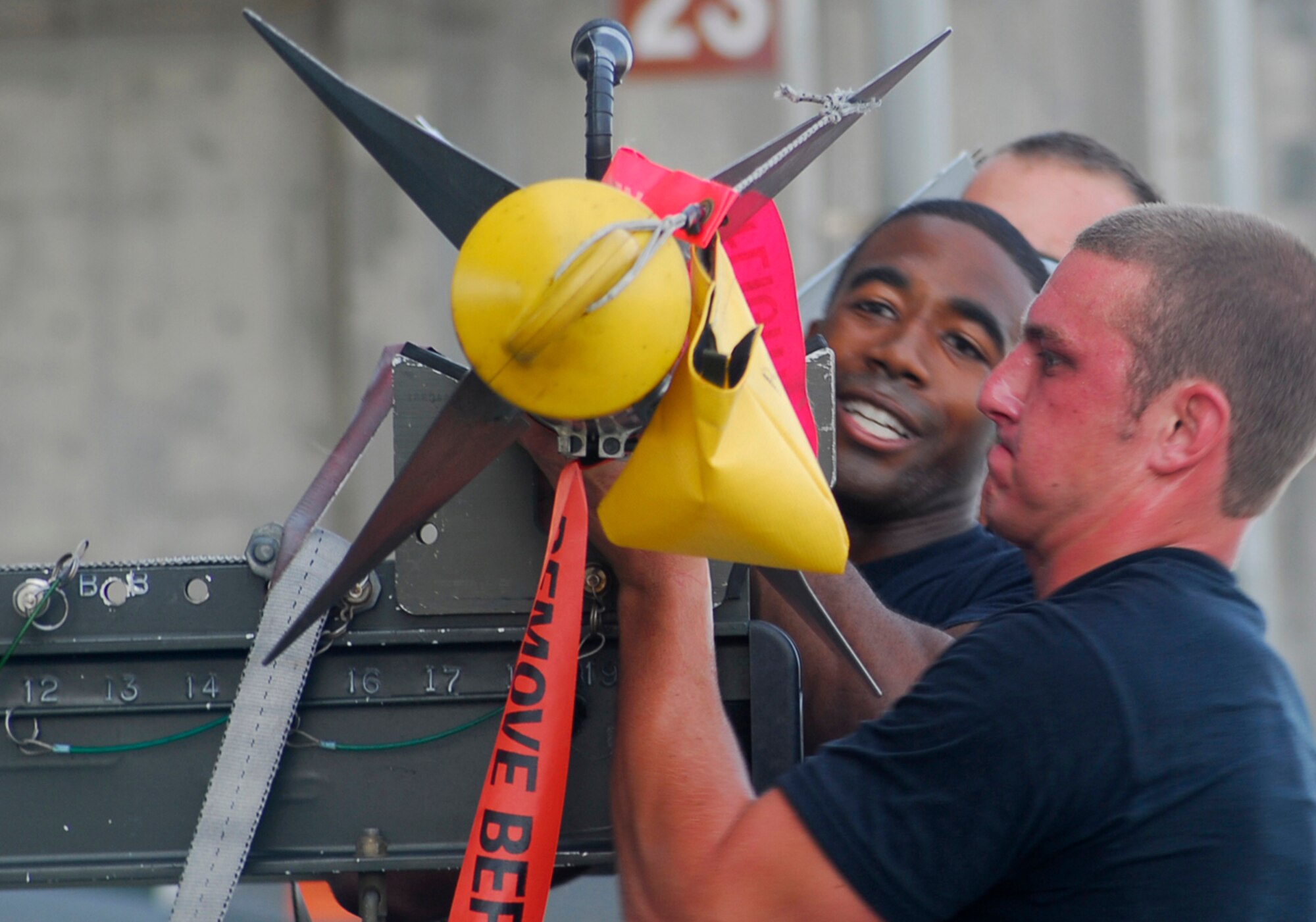 Senior Airman Joshua Weichert, right, and Staff Sgt. Alfred Agee lift an AIM-9 missile from the munitions trailer to load onto an F-15C Eagle during the Weapons Load Crew of the Quarter competition held here July 20. The two are assigned to the 18th Aircraft Maintenance Squadron, 67th Aircraft Maintenance Unit. (U. S. Air Force photo/Airman 1st Class Sheila deVera)
