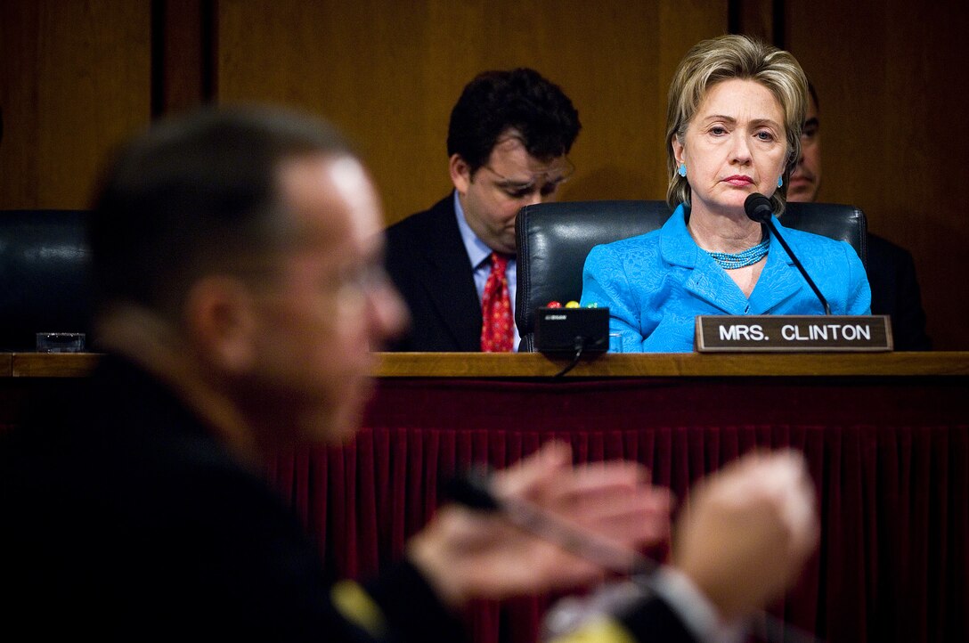 As Senator Hillary Clinton listens, Chief of Naval Operations, Adm. Mike Mullen responds to a question during his confirmation hearing in front of the Senate Armed Services Committee for appointment to Chairman and Vice-Chairman of the Joint Chiefs of Staff at Hart Senate Office Building, July 31, 2007. Mullen was joined by Commander, U.S. Strategic Command, Gen. James E. Cartwright for his appointment to Vice-Chairman of the Joint Chiefs of Staff.