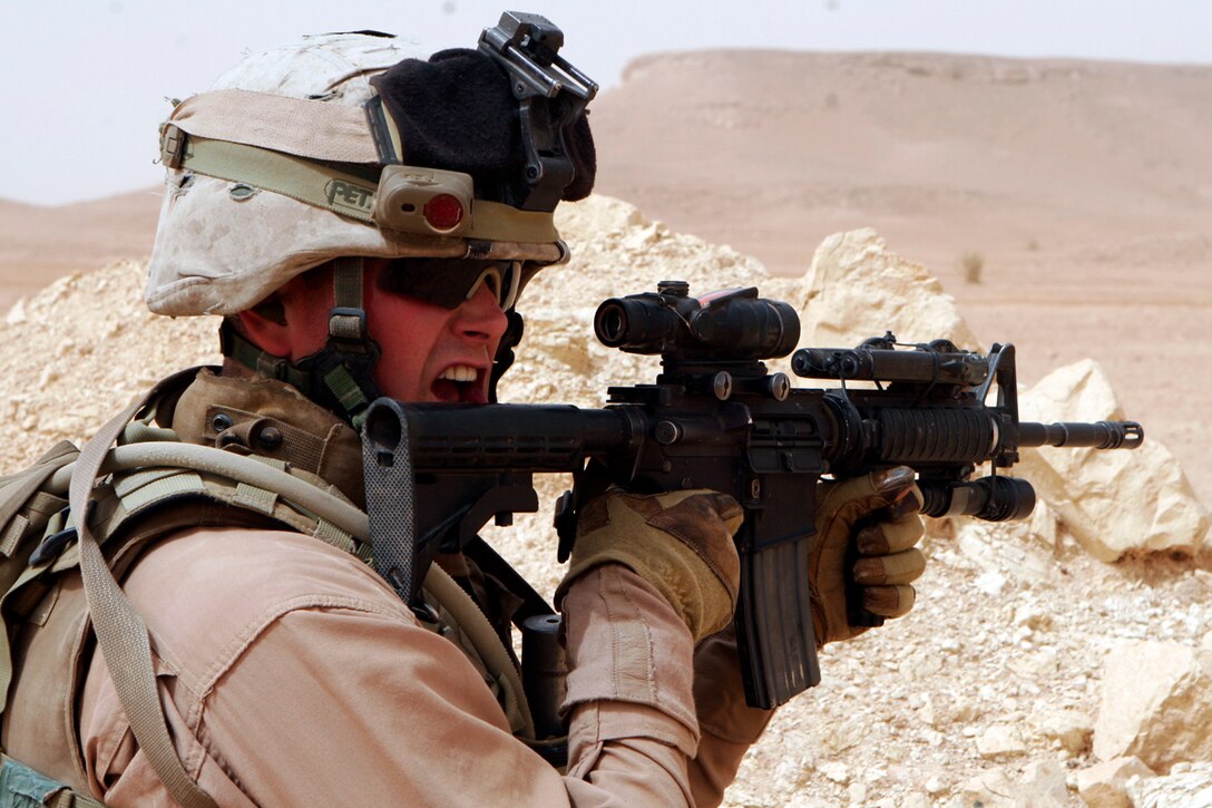 CAMP AL QA'IM, Iraq- Cpl. Kevin Knight, an assault team leader with Quick Reaction Force, Headquarters and Support Company, Task Force 1st Battalion, 4th Marines, attached to Regimental Combat Team 2 yells at his grenadier purposely adding stress to the training exercise.  Knight says the stress helps the Marines perform properly in a combat situation where stress can complicate simple tasks.