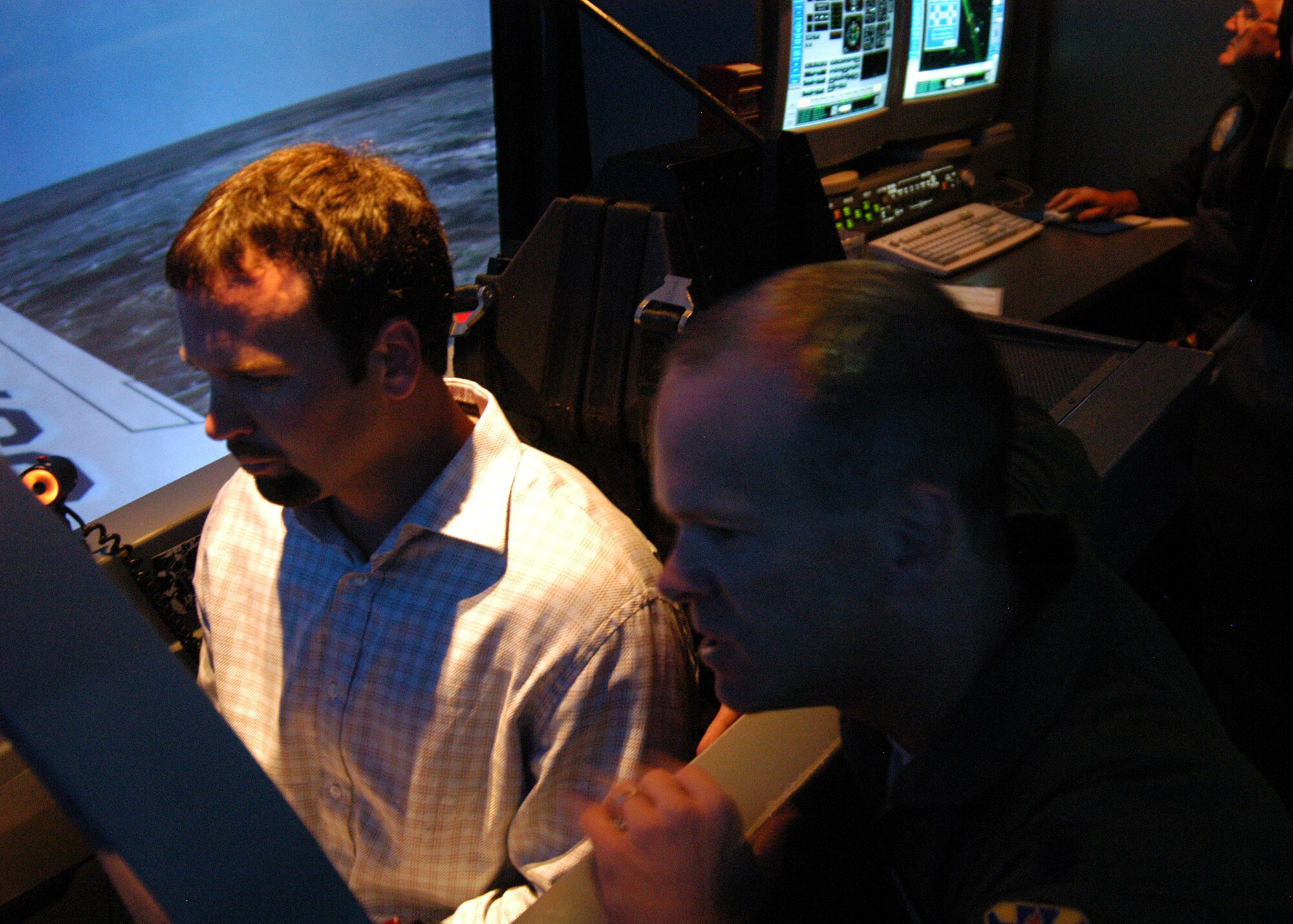 Indianapolis Colts Punter Hunter Smith experiences flying a T-6A Texan II in a simulator with coaching from Lt. Col. Chris Irwin, 559th Flying Training Squadron instructor pilot, during the team’s visit to Randolph Air Force Base, Texas, June 1. Coach Dungy, Bill Polian, team president and an Air Force Recruiting Service honorary commander, and Colts players Gary Brackett, Hunter Smith, Bob Sanders, Justin Snow and Adam Vinatieri visited the base to add to their knowledge of the Air Force and share their appreciation for the work of U.S. military servicemembers. (U.S. Air Force photo by Staff Sgt. Jennifer Lindsey)