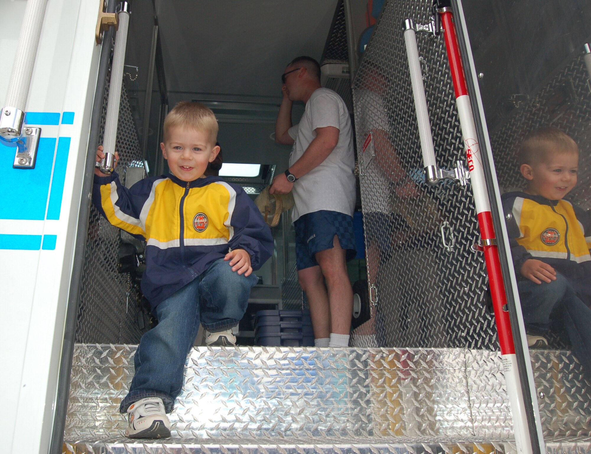 BUCKLEY AIR FORCE BASE, Colo. -- Joshua Achuff, son of the 8th Space Warning System's Senior Airman Jeff Achuff, plays on a Bureau of Alcohol, Tobacco, Firearms and Explosives emergency-response truck at the Buckley Sports, Field and Safety Day. The ATF briefed Buckley members about firearm safety. (U.S. Air Force photo by Senior Airman Jacque Lickteig)