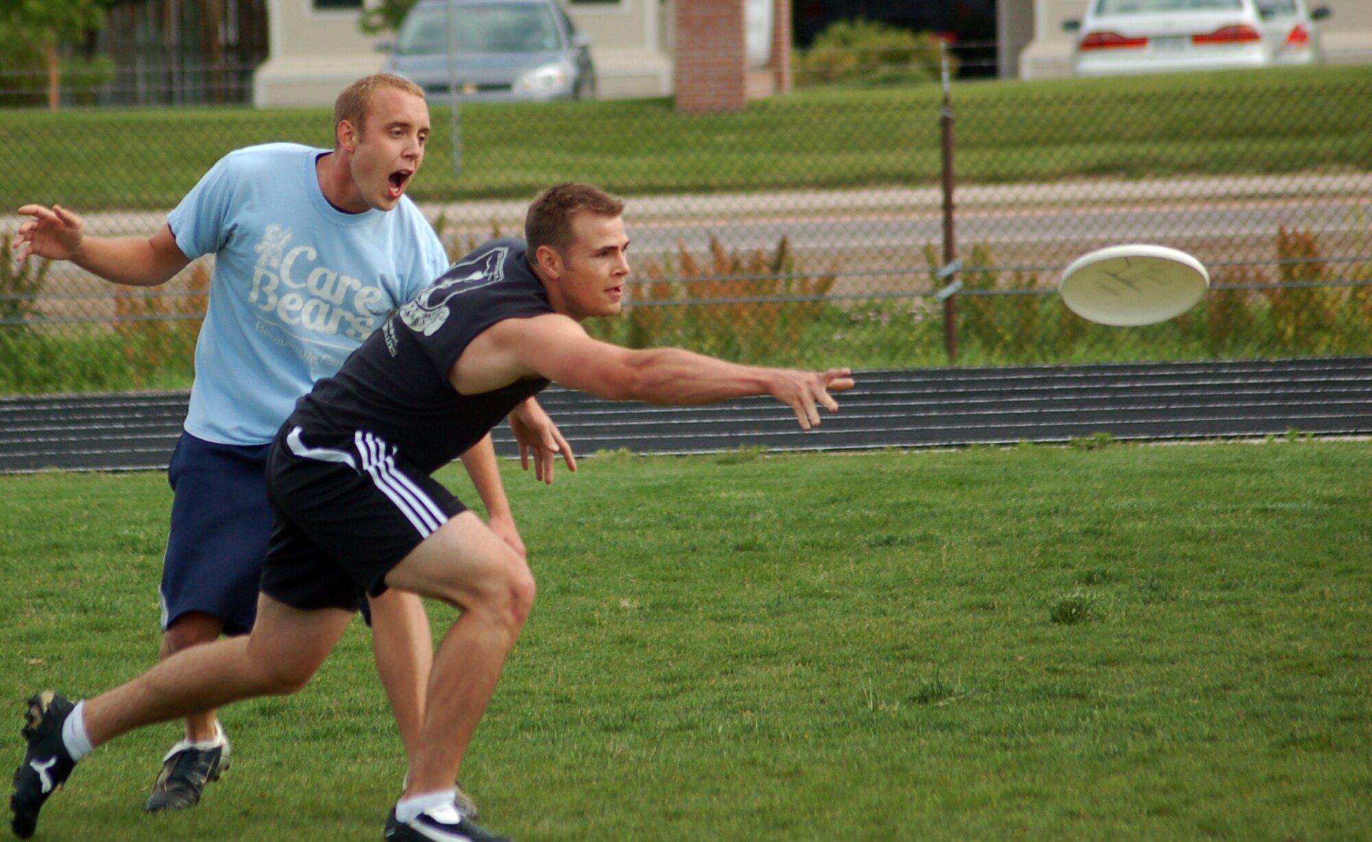 BUCKLEY AIR FORCE BASE, Colo. -- Senior Airman Orri Grow, from the 566th Information Operations Squadron, flings a frisbee in an ultimate frisbee game June 1. The game was part of the Buckley Sports, Field and Safety Day, which also included a 10 kilometer bike race, basketball, mushball, sand volleyball, tennis, a 400 meter run, a 100 meter dash, a tug of war and a 5 kilometer run/walk, and various safety demonstrations and booths. The event marked the beginning of the 101 Critical Days of Summer. (U.S. Air Force photo by Senior Airman Jacque Lickteig)