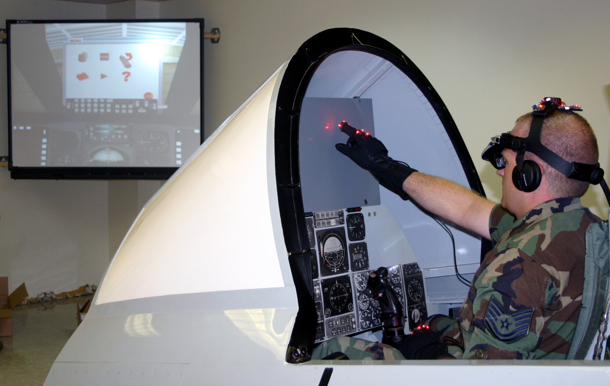 While the trainer still displays the cockpit controls of an A-10, the Generalized Operations Simulation Environment program, pictured on screen, shows the cockpit of an A-10C, as well as a function menu for the program's user. (U.S. Air Force photo/Staff Sgt. Tonnette Thompson)