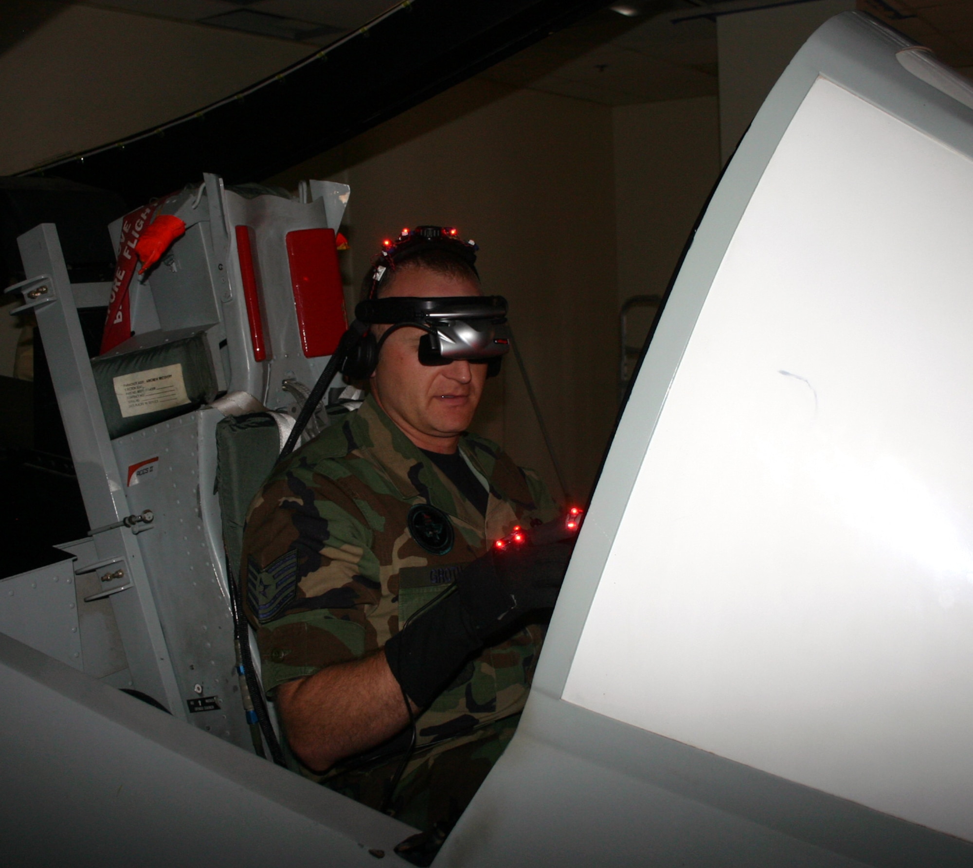 Tech. Sgt. Jason Groth, 363rd Training Squadron, demonstrates proper usage of the visor and gloves for the new Generalized Operations Simulation Environment program.  The program, developed by the Southwest Research Institute, uses virtual reality software and equipment to upgrade Sheppard's training courseware for the A-10 Thunderbolt II. (U.S. Air Force photo/Staff Sgt. Tonnette Thompson)