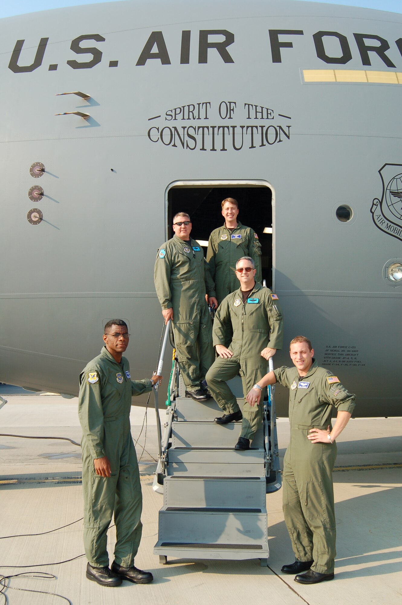 DOVER AIR FORCE BASE, Del. -- (Left to right) Master Sgt. Steve Rucker, 3rd Airlift Squadron loadmaster, Master Sgt. Mike Wright, 326th AS loadmaster, Maj. Justin Riddle, 3rd AS and the aircraft commander for this trip, Maj. Kevin Higginbotham, 326th AS, and Capt. Paul Scambos, 3rd Airlift Squadron's chief of C-17 tactics pose on the steps of Dover’s new C-17 Globemaster III after landing the aircraft at McGuire Air Force Base Thursday. The crew picked up the jet at Boeing’s Long Beach, Calif., production facility and flew it to McGuire, where it will remain until early Monday morning, when it will be flown to Dover and welcomed at a special arrival ceremony. (U.S. Air Force photo/2nd Lt. Nicole Langley)