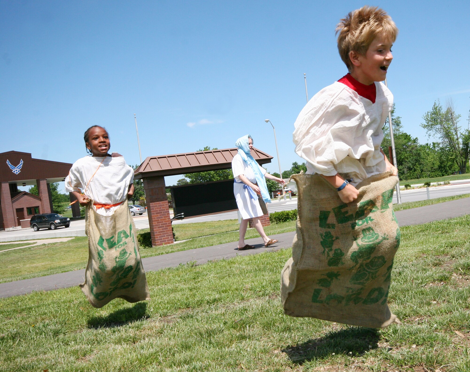 Terrance Peoples (left) and Luke Rincker, compete in a sack race during the Whiteman Chapel's Vacation Bible School, "Marketplace 29 A.D." June 1. (U.S. Air Force photo/Tech. Sgt. Matt Summers.) 