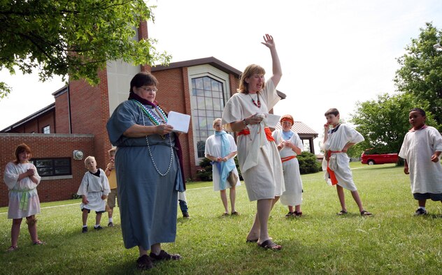 Cheri Maimer (left) and Tammy Templeton perform the story "God's Call from Slavery to Freedom" during the Whiteman Chapel's Vacation Bible School, "Marketplace 29 A.D." June 1. During the school, more than 30 children were divided into the 12 tribes of Israel and  were taught lessons about the Jewish religion and the Old Testament. A staff of more than 25 volunteers used numerous props, live animals and live music in their lessons. (U.S. Air Force photo/Tech. Sgt. Matt Summers.)