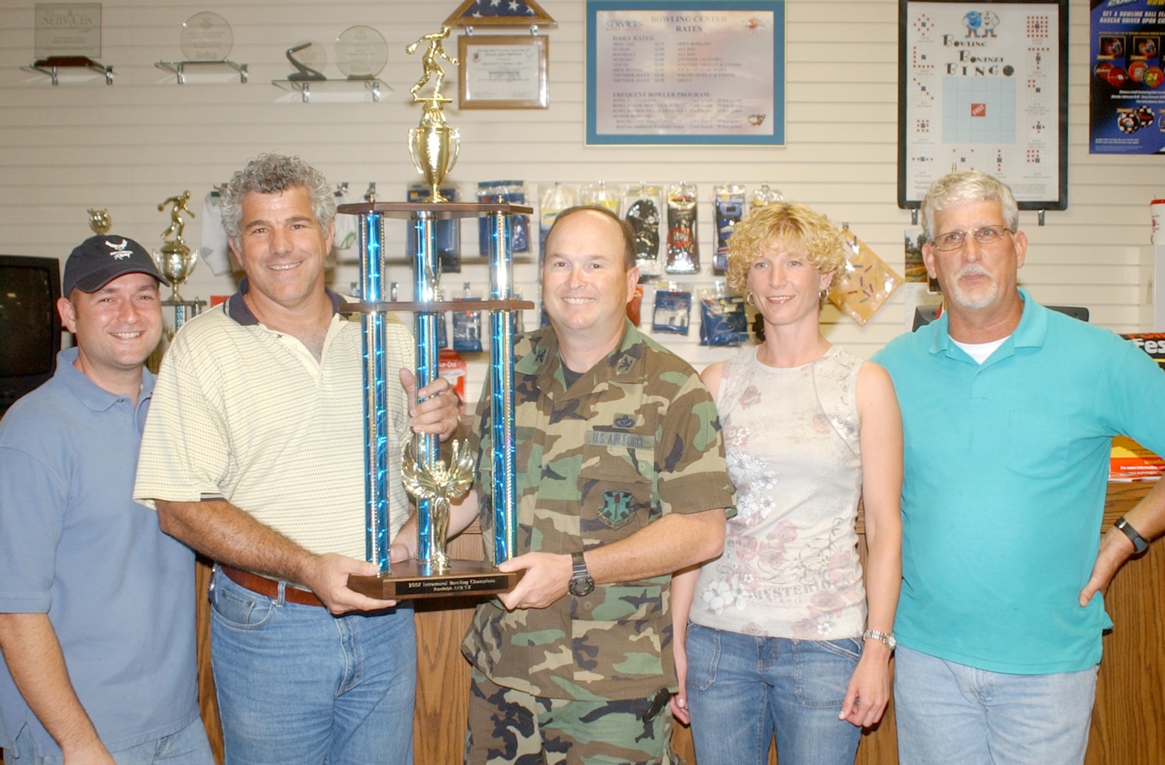 Col. James Sohan (center), 12th Mission Support Group commander, presents the first-place trophy for the Randolph Intramural Bowling League to the 12th MSG team represented by Doc Bolduc (left), Chris Goelz, Michelle Wiesmann and Kirk Mason. (U.S. Air Force photo by Robert Goetz)