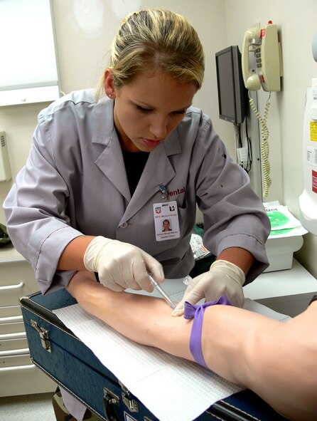 Senior Airman Ashley Harvey, 23rd Aerospace-Dental Squadron dental technician, practices starting an IV on one of the dental clinic's mannequin arms that was recently used to during an IV certification course held at Moody Air Force Base. (Photo by Airman 1st Class Sarah Johnson)