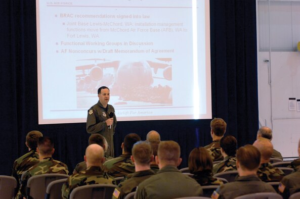 MCCHORD AIR FORCE BASE, Wash.--Col. Jerry Martinez, 62nd Airlift Wing commander, addresses a group of Airmen during a commander's call May 30 in Hangar 7. Commander's calls allow leadership to inform Airmen about base and Air Force-level changes while learning about the issues affecting Airmen during a question-and-answer session. Some of the issues discussed during this commander's call included the 101 Critical Days of Summer, force shaping, physical fitness and joint basing. (U.S. Air Force photo/Abner Guzman)