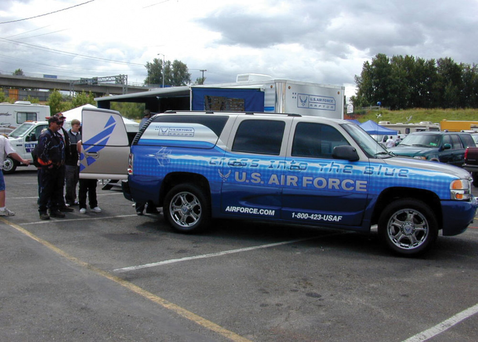 Recruiters allow potential recruits to play video games in the back of the 361st Recruiting Squadron's official Air Force recruiting vehicle while giving them information and pamphlets about Air Force careers recently at an outdoor festival. (U.S. Air Force photo)  