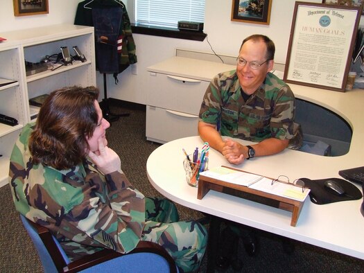 MCCHORD AIR FORCE BASE, Wash. -- Maj. Scott Johnson, the 62nd Airlift Wing's chief of Military Equal Opportunity, speaks with MEO superintendent Master Sgt. Sherri Chavez, 62nd AW, about the  office's upcoming installation climate assessment. (U.S. Air Force Photo/Tyler Hemstreet)