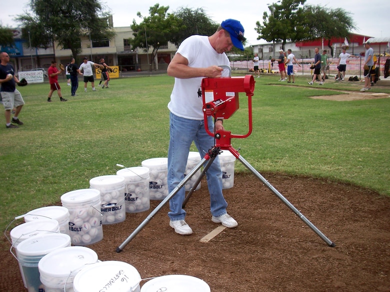 Senior Master Sgt. Tom Hren assembles a pitching machine that was donated to the Manta Baseball Academy in May in Ecuador. Sergeant Hren is assigned to the 190th Air Refueling Wing, which is deployed as part of the 478th Expeditionary Operations Squadron at Manta Forward Operation Location. (U.S. Air Force photo/Maj. Chris Hemrick)
