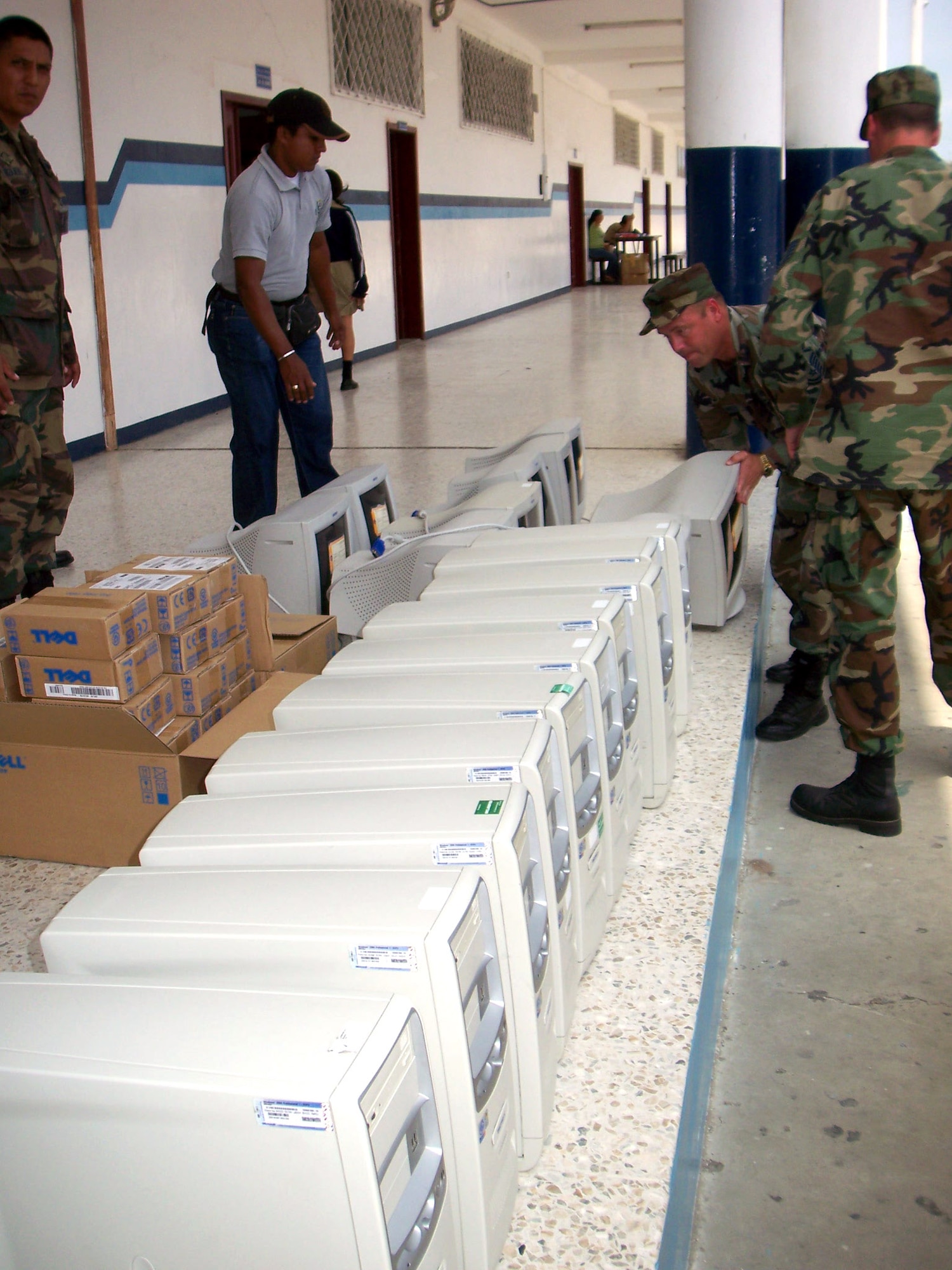 Volunteers from the 478th Expeditionary Operations Squadron unload computers for a high school in Ecuador. Airmen from Manta Forward Operation Location donated 10 computers, soccer balls and 3,000 pounds worth of textbooks to the school. (U.S. Air Force photo/Maj. Chris Hemrick)
