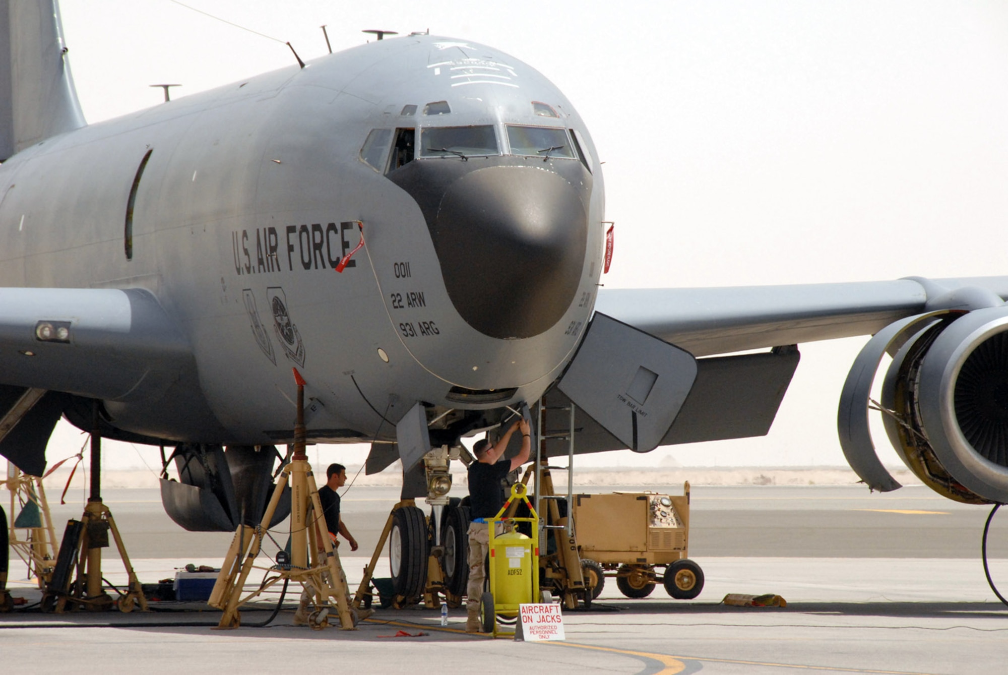 Two maintainers from the 380th Expeditionary Aircraft Maintenance Squadron prepare for a gear retraction operational check on a KC-135 Stratotanker May 30 at a deployed location in Southwest Asia. Coalition tankers off-loaded about 2.8 million pounds of fuel to more than 220 aircraft May 30. (U.S. Air Force photo/Master Sgt. Robert Burgess)