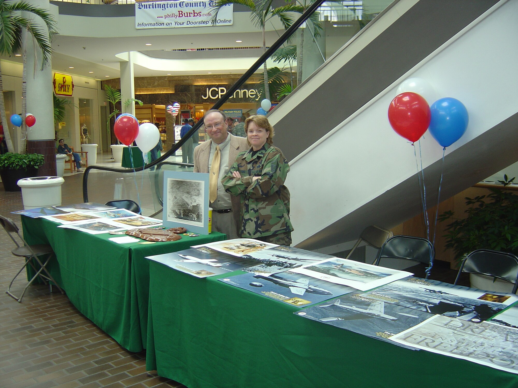 Gary Boyd, 305th Air Mobility Wing historian, and Master Sgt. Corinne Alvord, 305th Maintenance Group historical property custodian, man their Air Force history booth at the Burlington Mall Armed Forces Day May 19. They handed out historical posters and shared 60th Anniversary Air Force information with attendees. (U.S. Air Force photo by Capt. Anthony Duggan)  