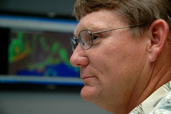 Tom Manning, 46th Weather Squadron forecaster at Eglin Air Force Base, Fla., monitors current weather conditions daily.  Mr. Manning has more than 17 years of tropical storm experience as a weather forecaster. (Air Force photo by Staff Sgt. Mike Meares) 