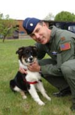 ANDREWS AIR FORCE BASE, Md. -- Maj. Eddie Miller, 459th Air Refueling Wing safety chief and pilot, poses with Jackson. (U.S. Air Force photo/Master Sgt. Shayne Sewell)