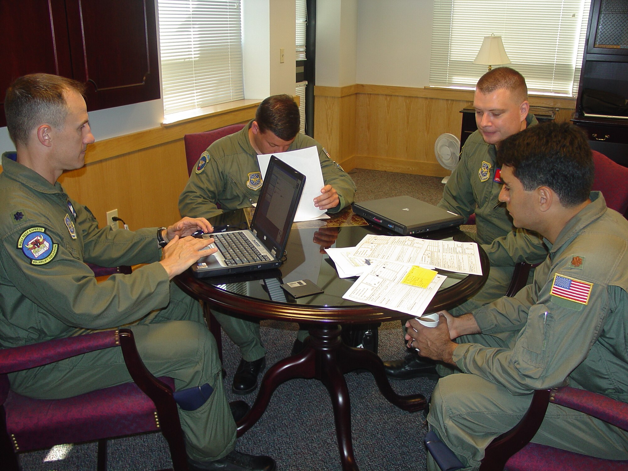 Section three, led by Lt. Col. Geoff Norton (left), 6th ALS director of operations, at the aviation fuels savings implementation meeting here Wednesday. They discussed ways to implement fuel accountability initiatives identified by the Pentagon  for the KC-10 and C-17. (U.S. Air Force photo by Airman Rebekah Phy)