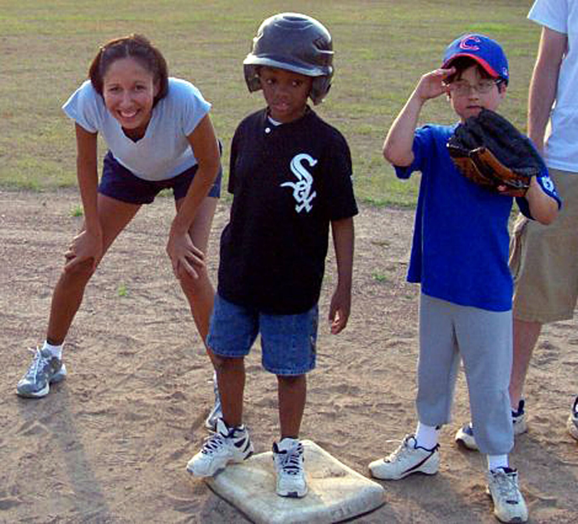 Staff Sgt. Renee Ortega, 128 Airborne Command and Control Squadron airborne intelligence technician, acts as a "Buddy" for Jimarco of the Macon Miracle League White Sox, May 29. (Coutesy Photo)    