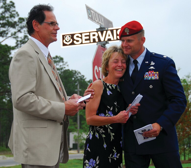 Sue Servais, mother of fallen Air Force combat controller Senior Airman Adam Servais, is embraced by Lt. Col. Eric Ray, commander of the 23rd Special Tactics Squadron, during the street-naming ceremony Wednesday.  (U.S. Air Force photo by Chief Master Sgt. Gary Emery)