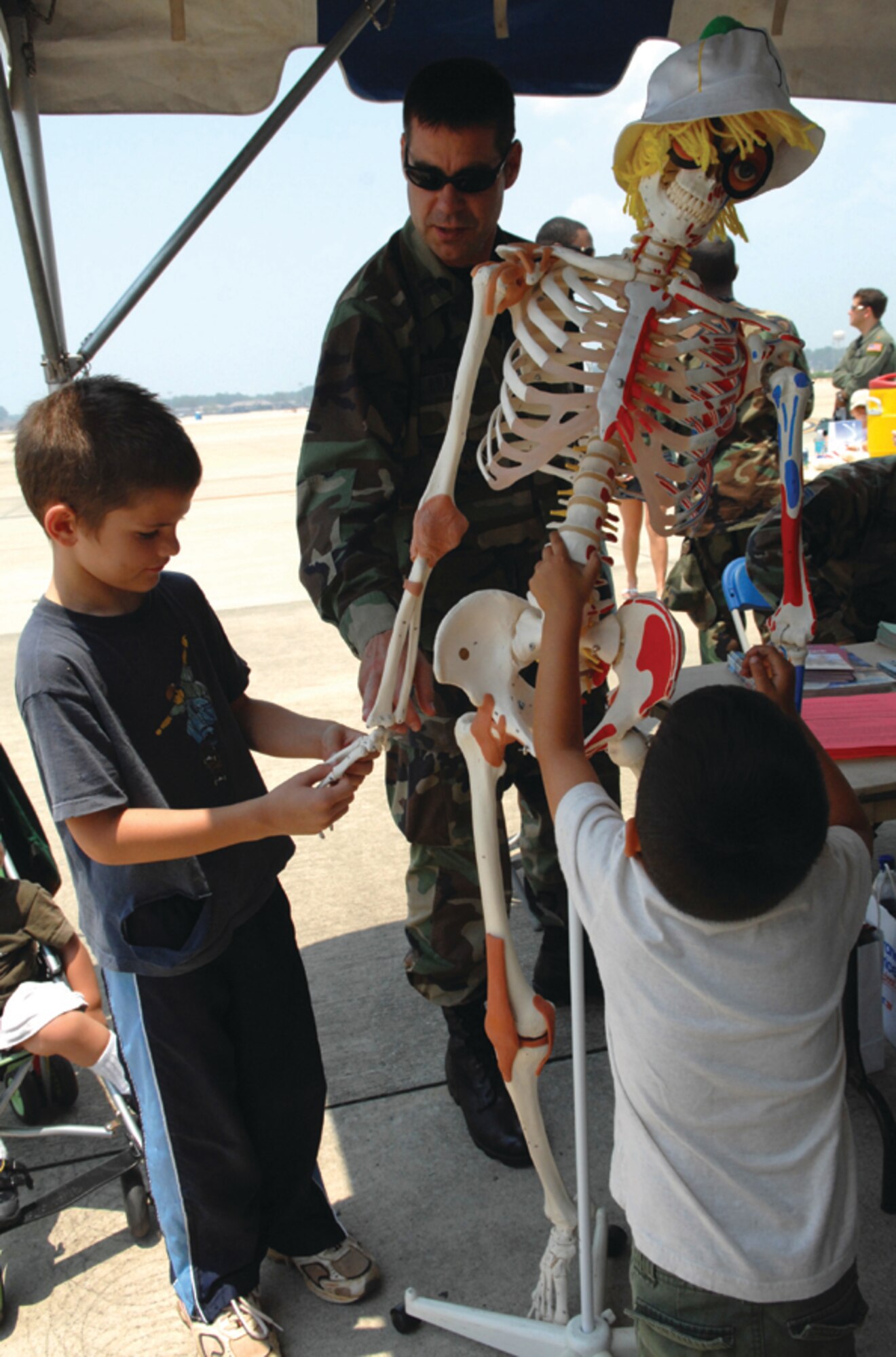 Capt. David Brazeau, 1st Special Operations Medical Operations Squadron, shows children a skeleton of the human body during Hurlburt Field’s Family Day on May 24. (U.S. Air Force photo by Senior Airman Ali Flisek)