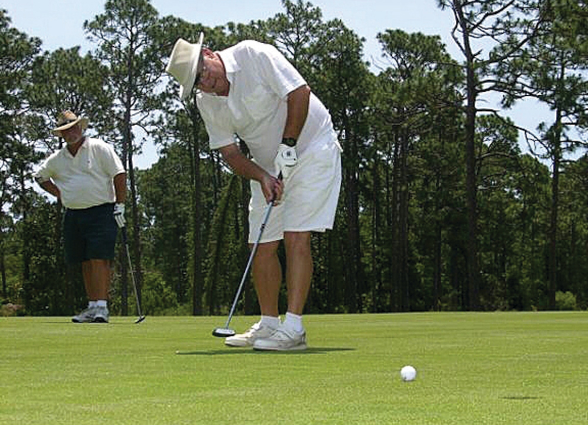 A golfer lines up a putt on one of the new putting greens at Gator Lakes Golf Course. The course re-opened May 25 with all new putting greens and other new programs for golfers. (U.S. Air Force photo by Jon Ortiz)