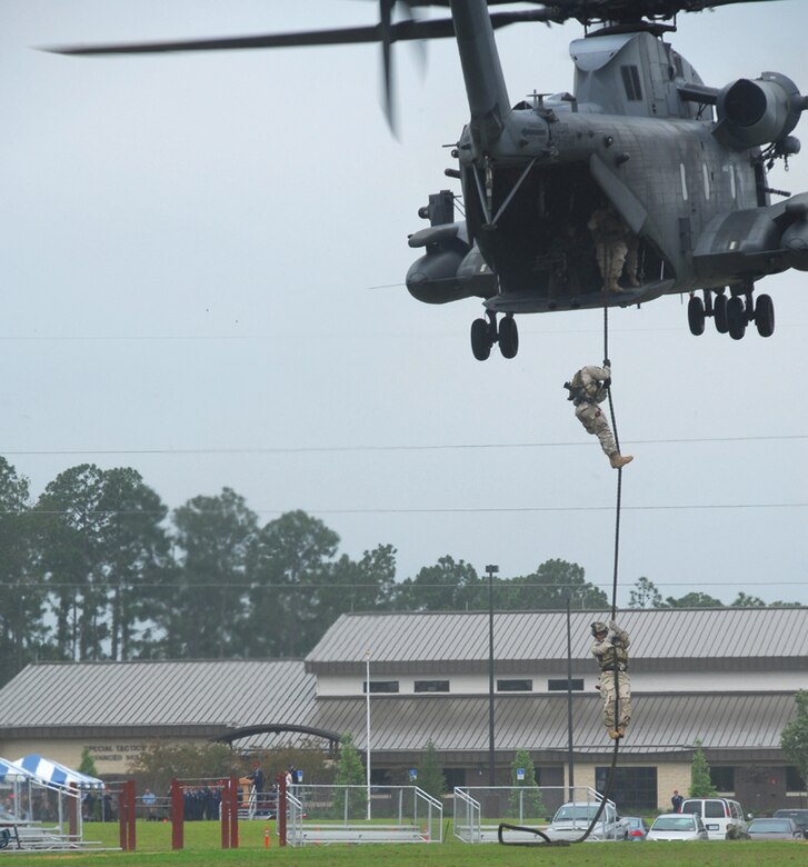 Special Tactics Airmen fast rope from an MH-53 PAVE LOW during a ceremony Wednesday dedicating the Advanced Special Tactics training building to four special tactics Airmen who were killed in the line of duty. (U.S. Air Force photo by Chief Master Sgt. Gary Emery)