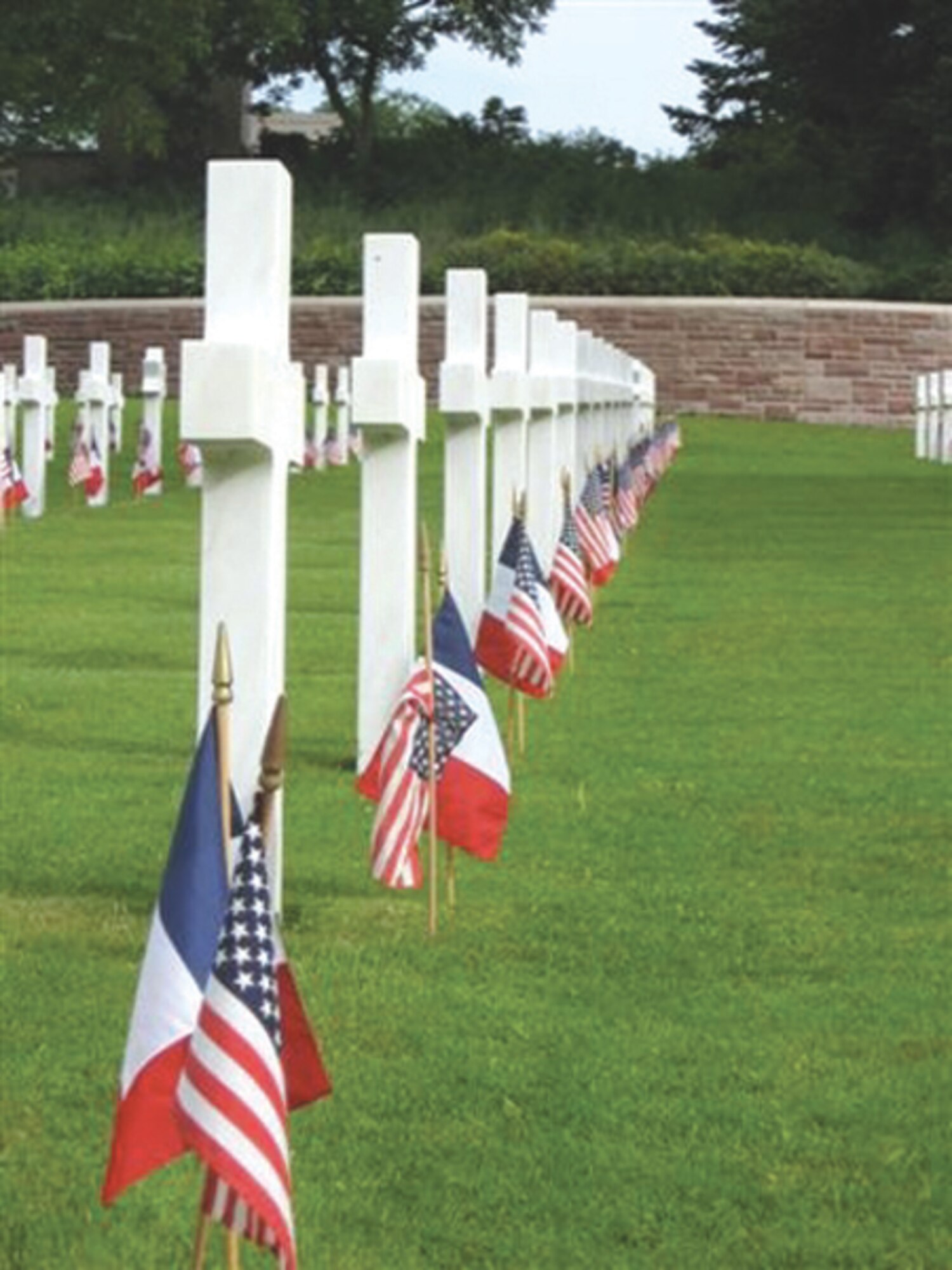 ST. AVOLD, FRANCE --  A group of 25 Scouts from Spangdahlem Air Base traveled to St. Avold, France, to prepare the cemetery for a Memorial Day ceremony. More than 20,000 flags were placed in formation in preparation for the ceremony. This is an annual service project for the Girls Scouts from Spangdahlem and Sembach. The girls camp at a nearby camp ground and spend the weekend work with French Guides in an effort to honor the World War II Soldiers who paid the ultimate sacrifice. (Photo by Michelle DeMers)