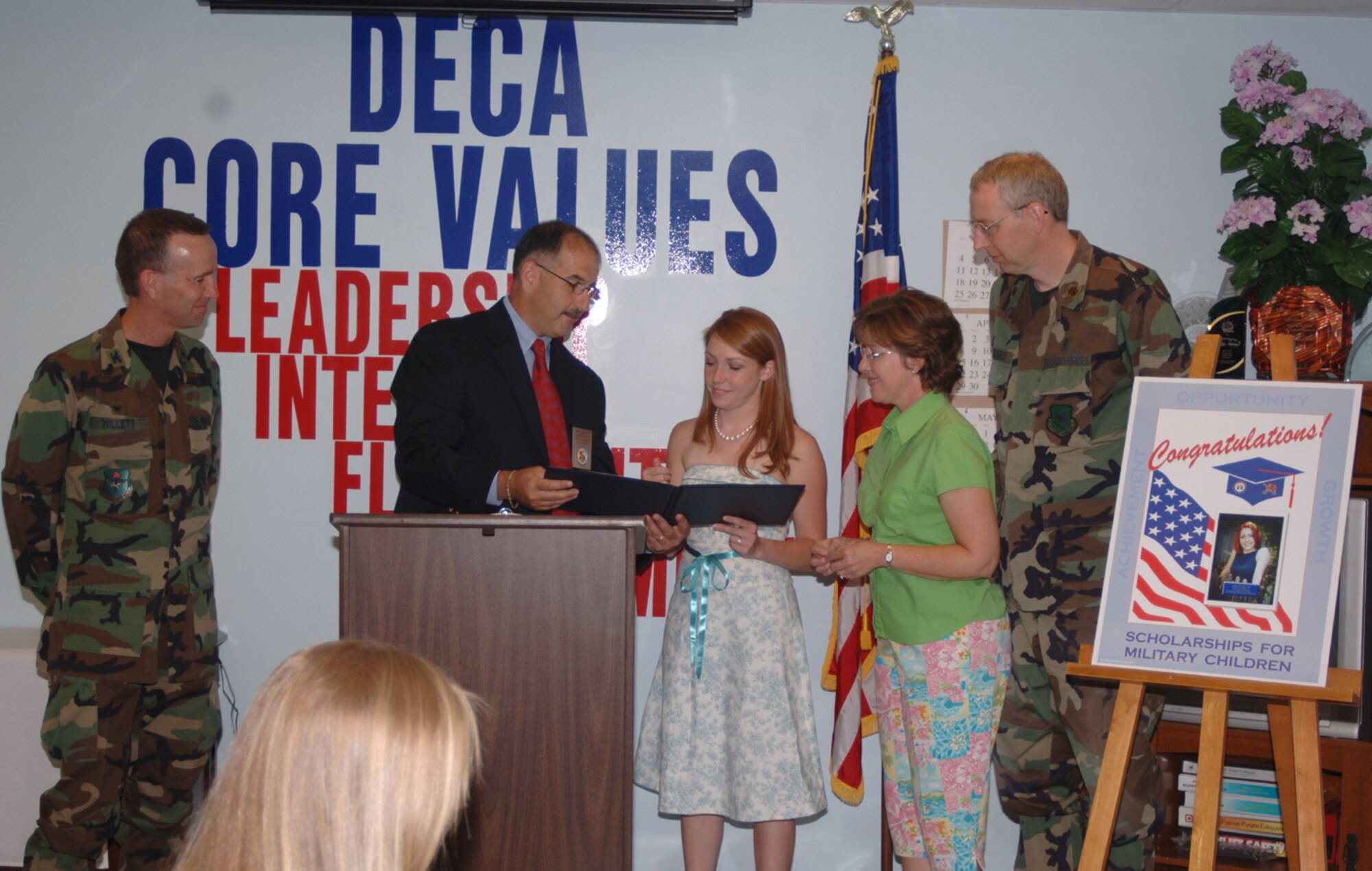 April Taylor, daughter of Maj. William Hubbard, was awarded the Defense Commissary Agency Scholarship for Military Children Tuesday. She is pictured here with Colonel Eugene Willett, 14th Mission Support Group commander, Keith Laughinghouse, CAFB DeCA representative, and her parents, Maj. and Mrs. Hubbard. Ms. Taylor is a senior at  Lipscomb University in Nashville, Tenn., where she is majoring in social work. (U.S. Air Force Photo/Airman 1st Class Danielle Powell)