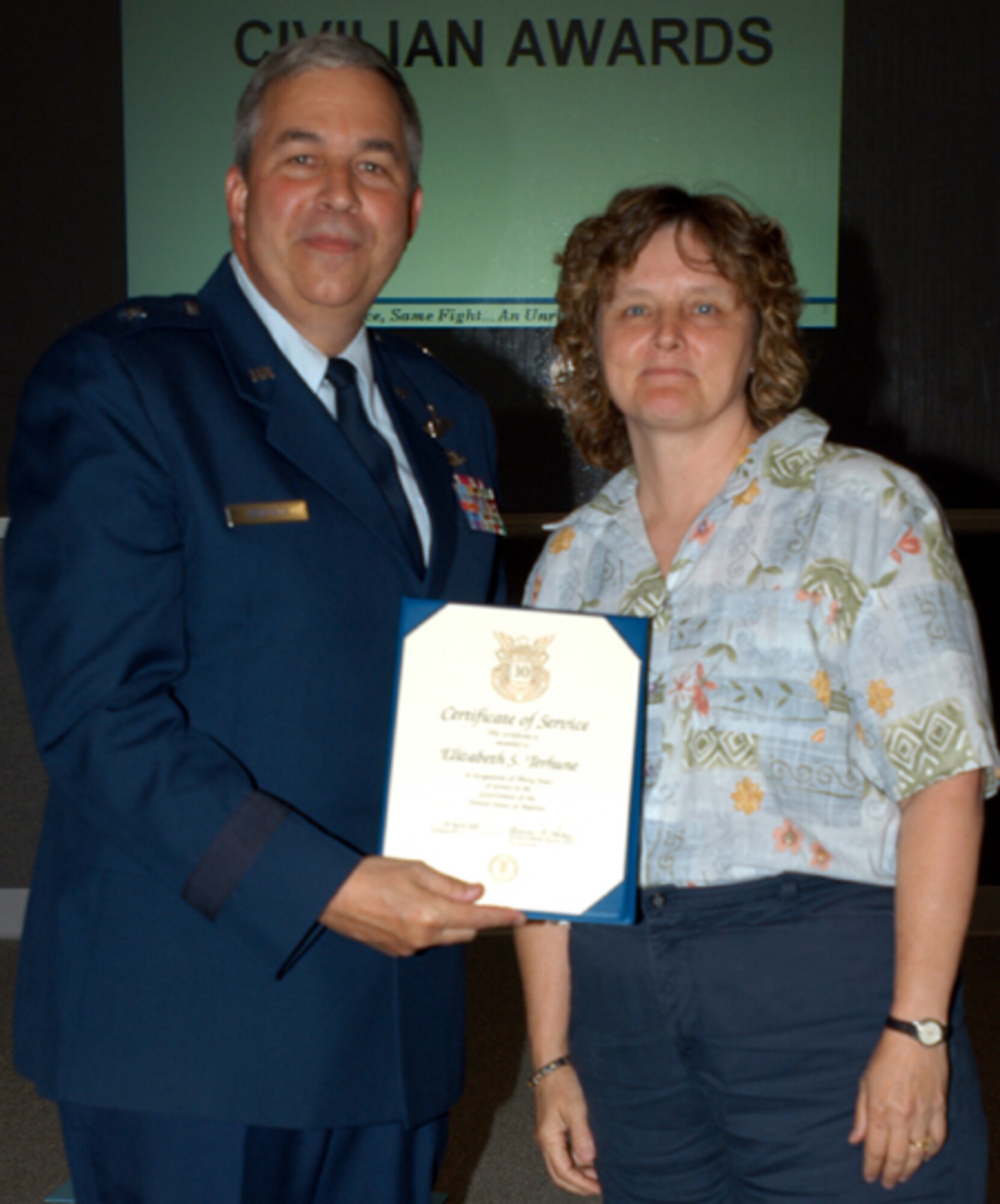GRISSOM AIR RESERVE BASE, Ind., -- SueTerhune, base contracting specialist, receives a pin and certificate marking 30 years of civil service from Brig. Gen. Dean Despinoy, 434th Air Refueling Wing commander. The pin and certificate were presented during a special civlian commander's call recently. (U.S. Air Force photo/Tech. Sgt. Doug Hays)