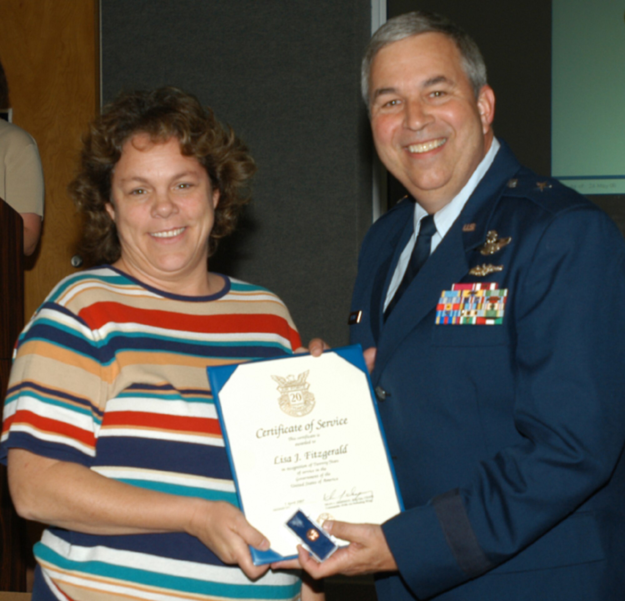 GRISSOM AIR RESERVE BASE, Ind., -- Lisa Fitzgerald, base education and training office, receives a 20-year pin and certificate from Brig. Gen. Dean Despinoy, 434th Air Refueing Wing commander. The presentation was made during a special civilian commander's call held recently. (U.S. Air Force photo/Tech. Sgt. Doug Hays)