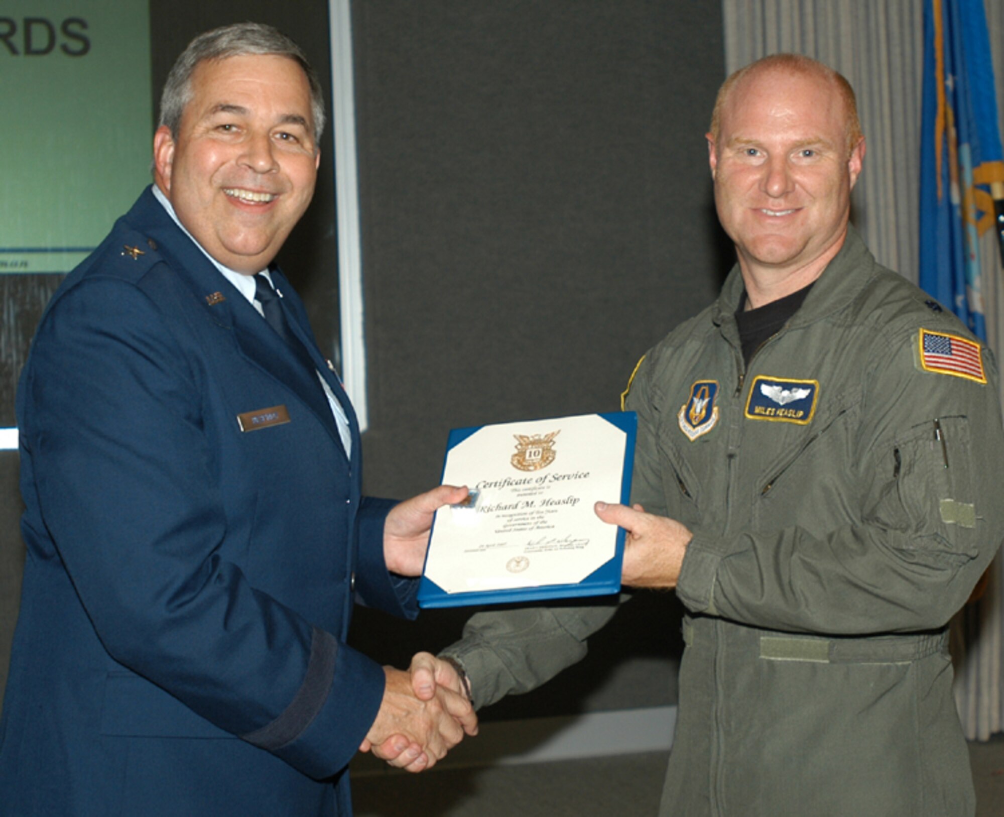 GRISSOM AIR RESERVE BASE, Ind., -- Maj. Miles Heaslip, right, 72nd Air Refueling Squadron, receives a pin and certificate marking 10 years of civil service from Brig. Gen. Dean Despinoy, 434th Air Refueling Wing commander. The presentation was made during a recent civilian commander's call. (U.S. Air Force photo/ Tech. Sgt. Doug Hays)