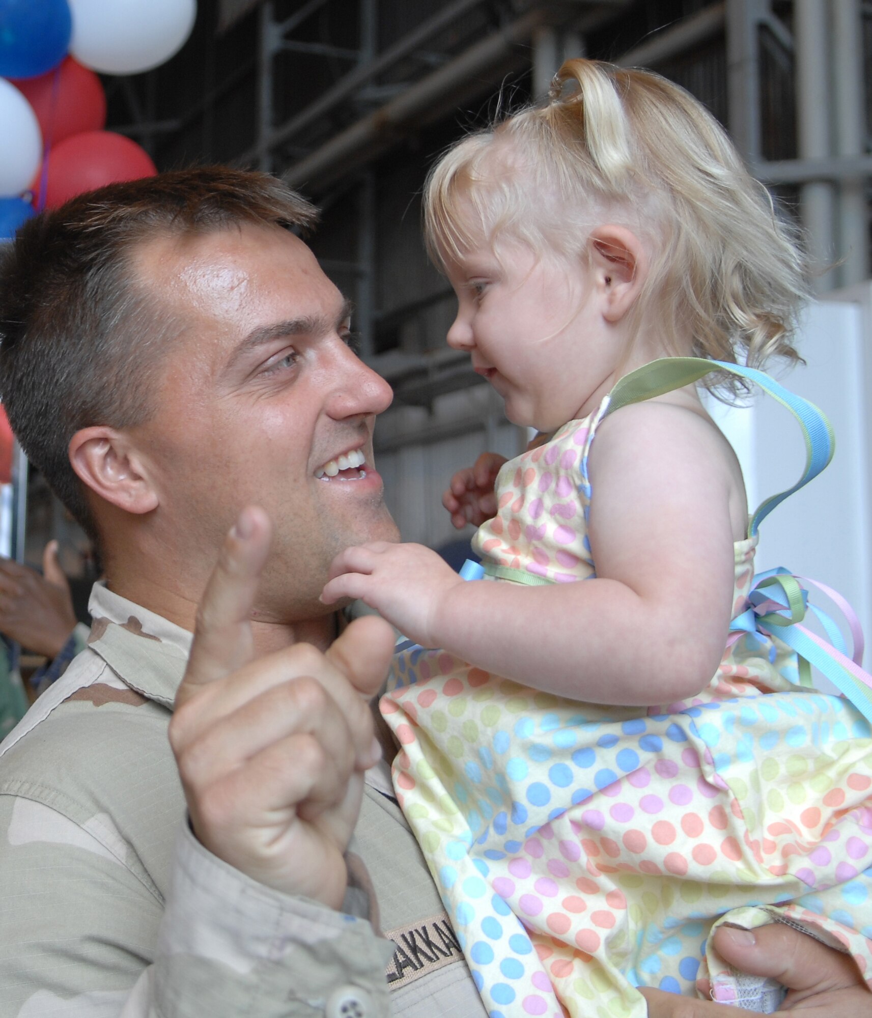 Tech Sgt Christopher Lakkala, 31st Maintenance Squadron, greets his daughter Rachel after returning from a deployment in support of the Global War on Terror. (U.S. Air Force Photo by Staff Sgt. Bethann Caporaletti)