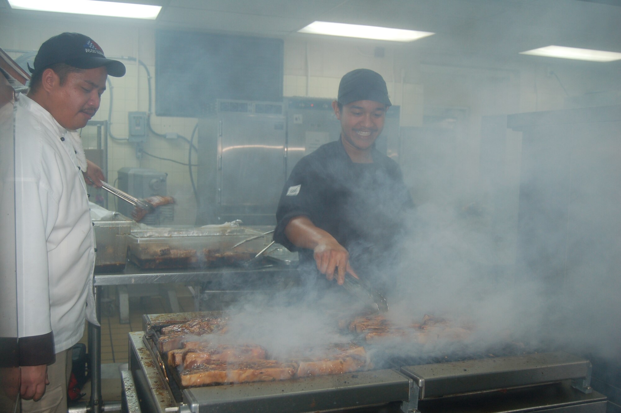 A chef from the Old Hagatna Grill adds finishing touches to short ribs May 24 using the facilities available at the Magellan Inn.  The Old Hagatna Grill hosted an appreciation meal for Airmen and their families May 24 to thank them for their service and share Guam dining options available off-base. (Photo by Airman 1st Class Carissa Morgan/The Pacific Edge)