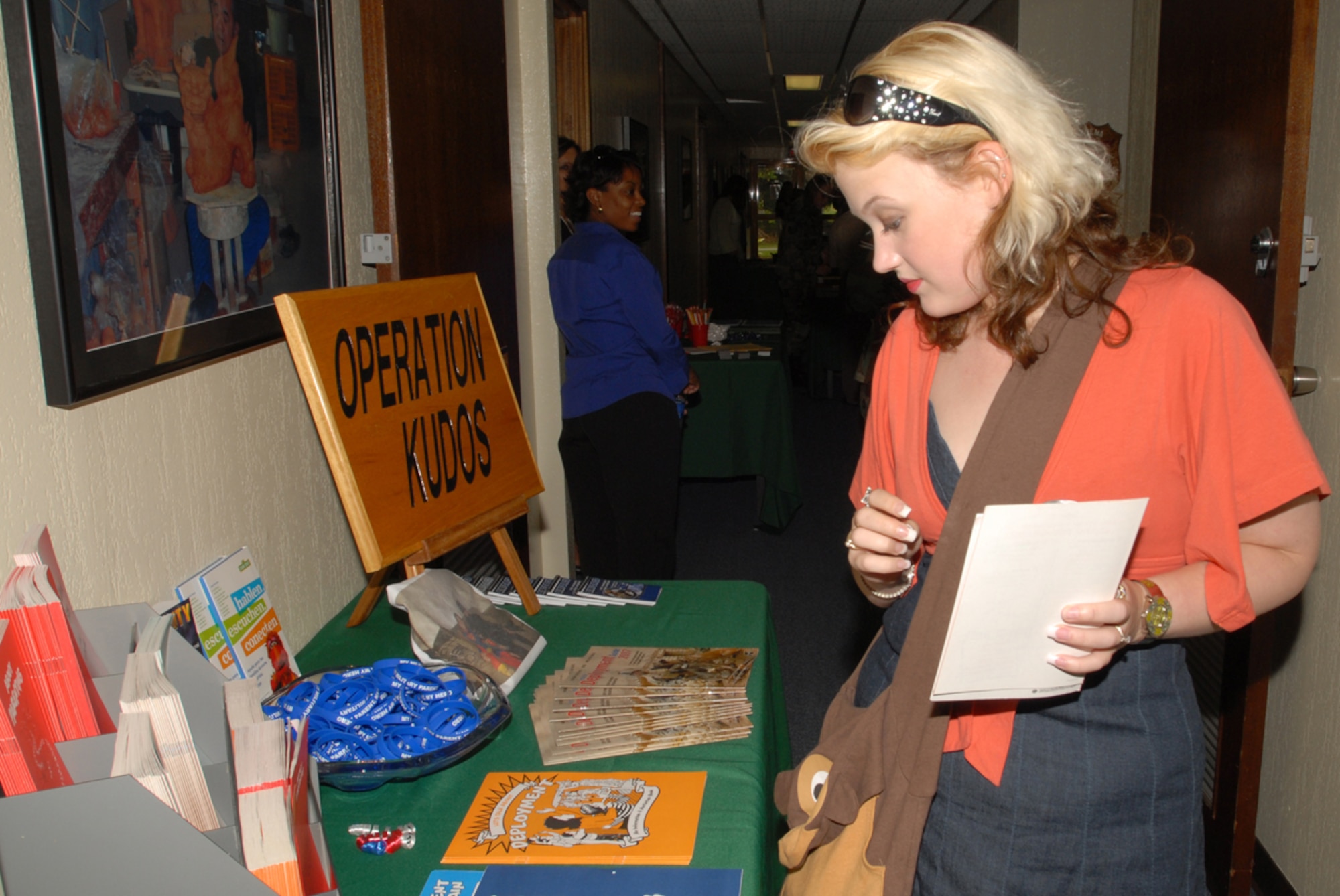 Kalistae Hine, wife of Senior Airman Nicholas Hine from the 18th Equipment Maintenance Squadron, looks at information on a table during the month of the military spouse and AEF 7/8 family readiness fair at Kadena Air Base, Japan, May 31.
(U.S. Air Force/Airman 1st Class Kasey Zickmund)