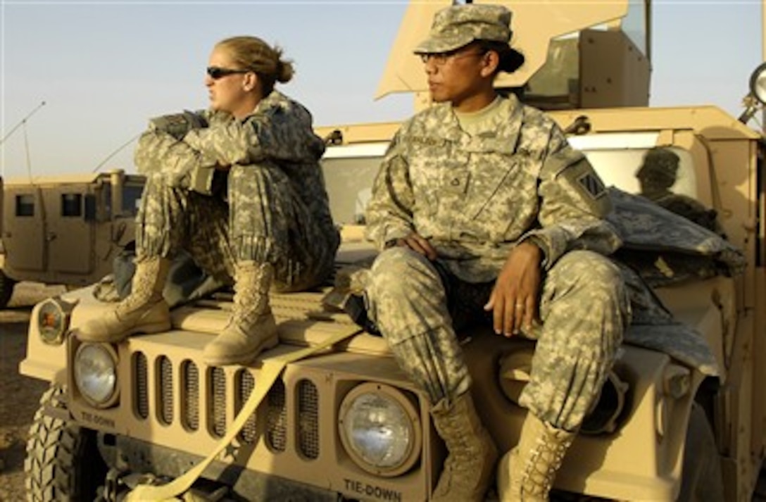Two U.S. Army soldiers from Brigade Support Troop Battalion, Headquarters Company, 3rd Brigade, 3rd Infantry Division relax prior to departing on a mission from Forward Operating Base Hammer in Iraq on May 21, 2007.  
