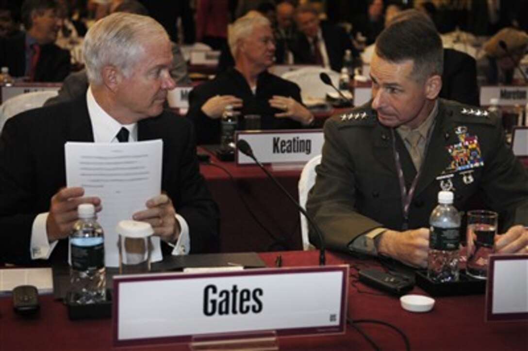 Defense Secretary Robert M. Gates speaks with U.S. Marine Gen. Peter Pace, chairman of the Joint Chiefs of Staff, after delivering remarks at the 6th International Institute for Strategic Studies conference, the Shangri-La dialogue, in Singapore, June 2, 2007. 