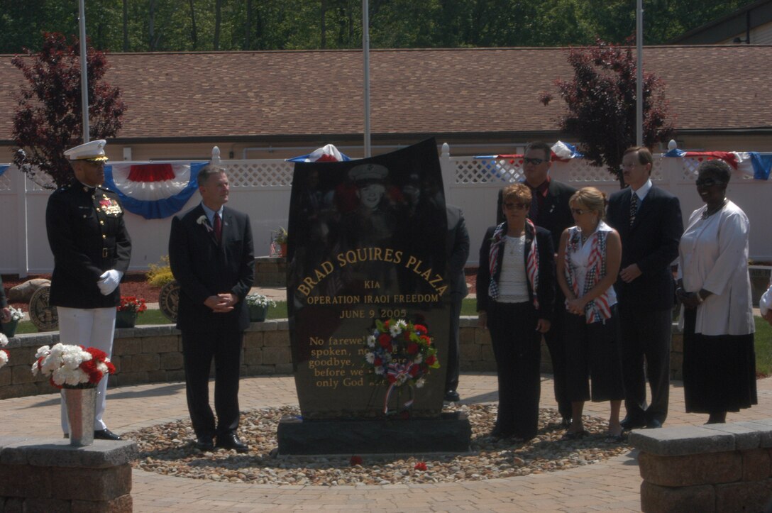 Brig. General James L. Williams and Mayor Gary W. Starr stand with the family of Cpl. Brad Squires and Congresswoman Stephanie Tubbs Jones after the unveiling of the central plaque during the dedication ceremony of the Brad Squires Plaza June 2, in Middleburg Heights, OH. The memorial plaza honored all of Ohio's fallen troops since 2003.