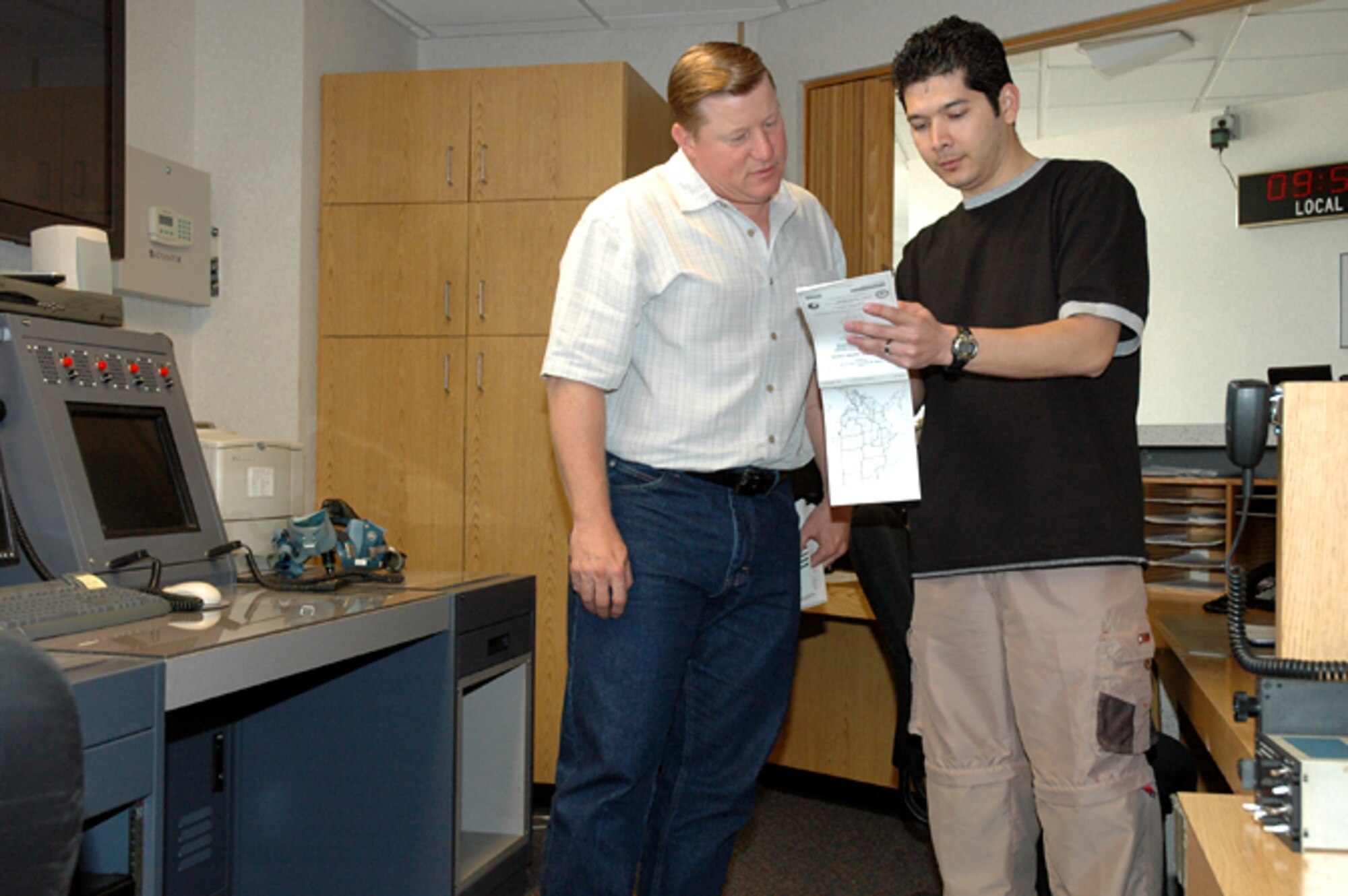 Jim DeCann and Paul Guardado check flight routes at Base Operations
