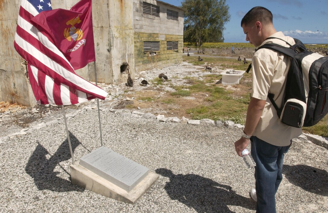 Cpl. Mitch Oshkeshequoam, U.S. Marine Corps Forces, Pacific personnel security NCO, reads the memorial for Lt. George Cannon, the first Marine Medal of Honor recipient of World War II, who drug his men out of a command post that was bombed during an attack on Midway Atoll.  More than 1,600 people, including a handful of World War II veterans, visited Midway Atoll June 4 for a commemoration ceremony in recognition of the 65th anniversary of the Battle of Midway.