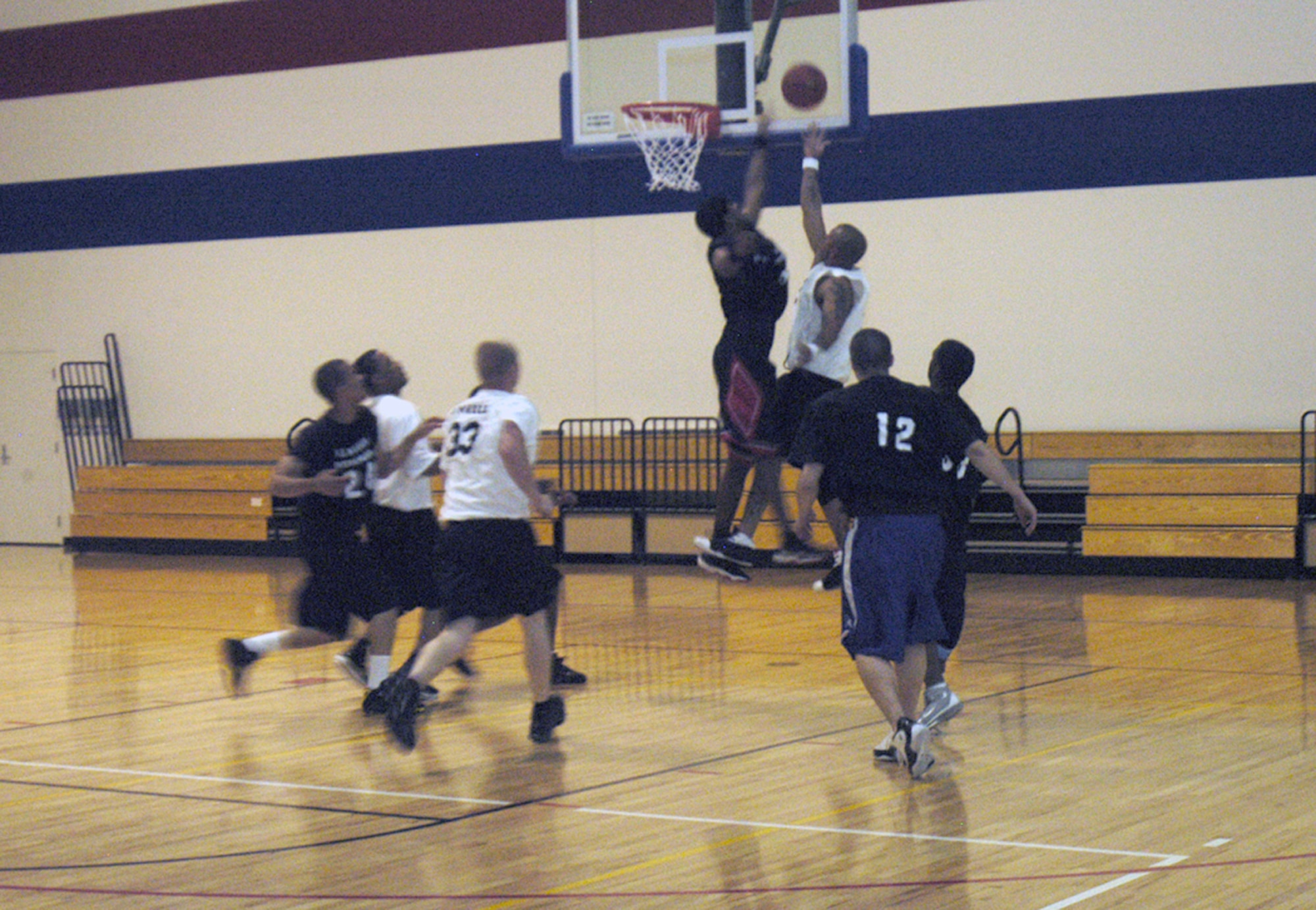 A Warren Wranglers player takes a shot over the arm of a player from the Collette’s Ballers team during the basketball tournament at Freedom Hall gymnasium May 18. The Warren Wranglers won the three-day tournament held by the Warren African-American Heritage Council in honor of Armed Forces Day (Photo by 2nd Lt. Lisa Meiman).